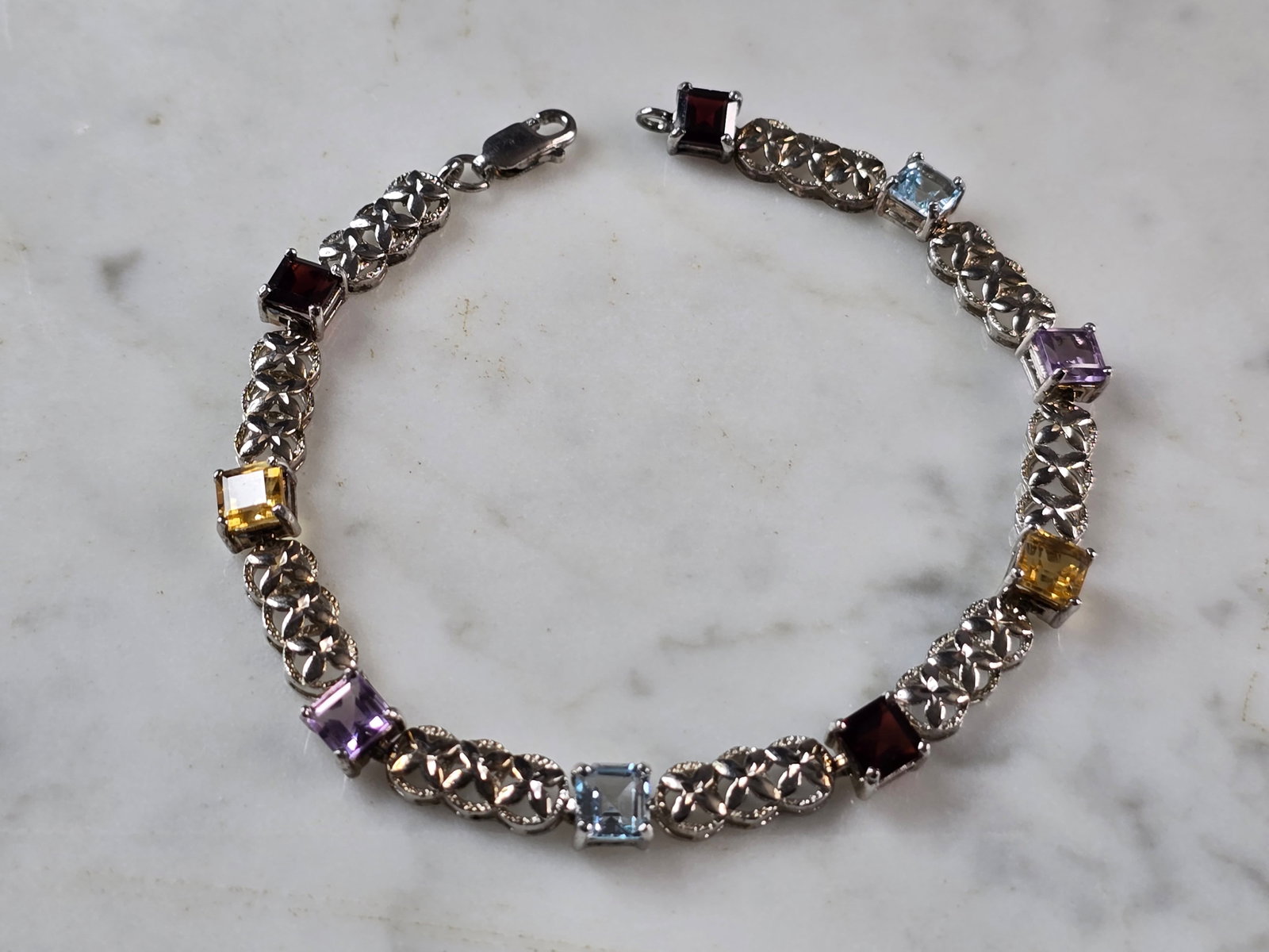 Womens Vintage Estate Sterling Silver Multi Stone Bracelet: A WOMENS VINTAGE ESTATE STERLING SILVER MULTI STONE BRACELET. BRACELET MEASURES 7 3/4" LONG BY 1/4" WIDE, AND WEIGHS 10.1g. NOT SURE IF STONES ARE NATURAL OR MAN MADE. THIS WOULD MAKE A LOVELY GIFT FO