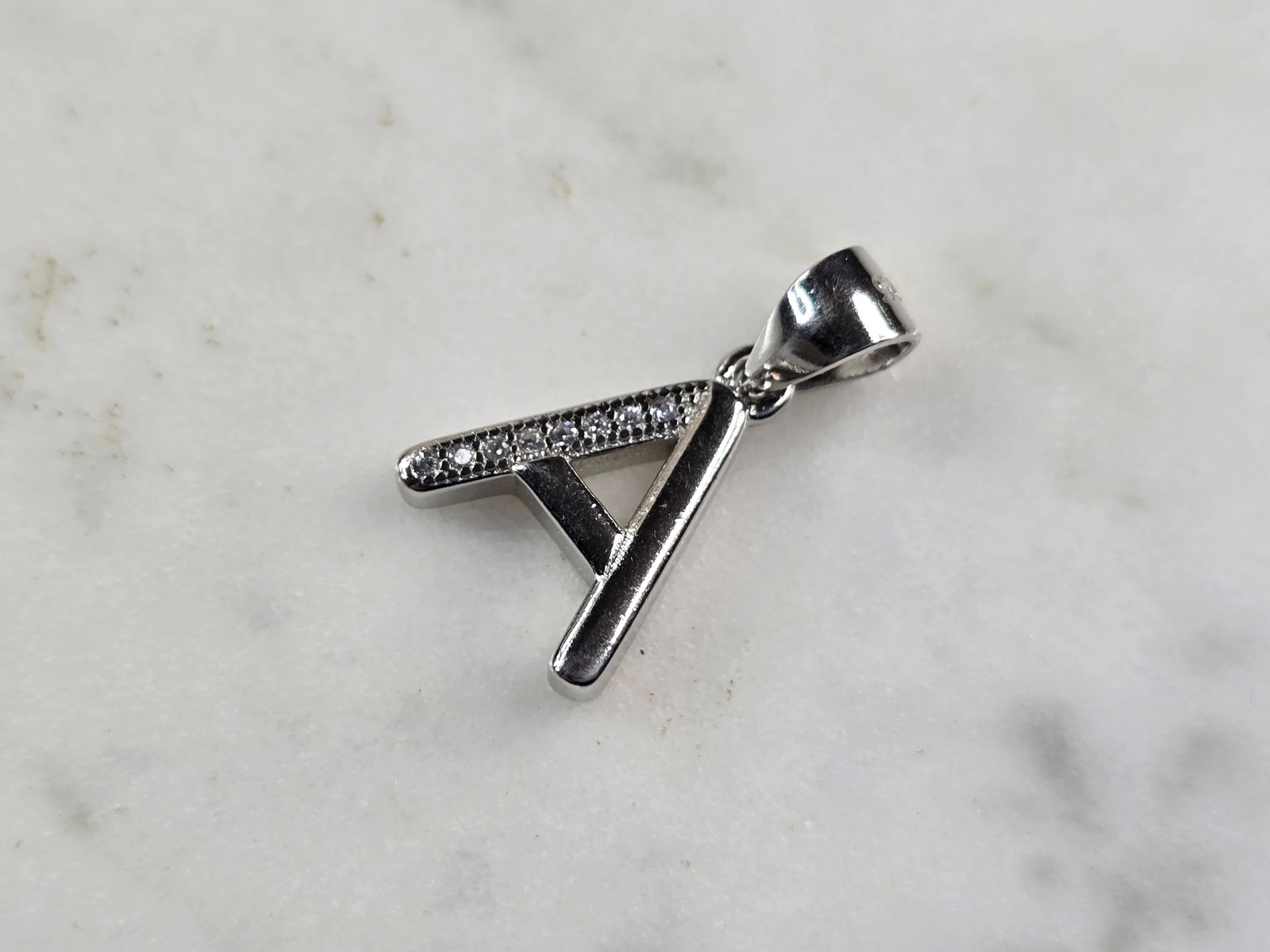 Womens Vintage Estate Sterling Silver CZ Letter "A" Pendant: FOR SALE IS THIS WOMENS VINTAGE ESTATE STERLING SILVER CZ LETTER "A" PENDANT. PENDANT WEIGHS 1.6g AND PENDANT MEASURES 3/4" LONG BY 1/2" WIDE. MAKES A GREAT GIFT FOR THAT SOMEONE SPECIAL. IF ANY QUEST