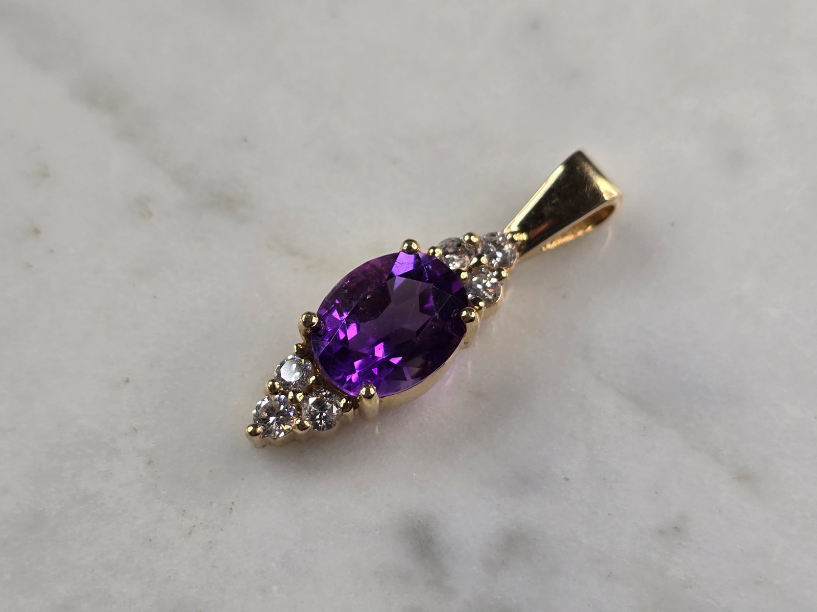 Womens 14K Yellow Gold Amethyst Diamond Pendant: FOR SALE IS THIS LOVELY VINTAGE ESTATE 14K YELLOW GOLD AMETHYST & DIAMOND PENDANT. THE PENDANT WEIGHS 3.5g AND MEASURES 1 1/8" LONG BY 1/4" WIDE. THERE ARE ABOUT .30cts OF DIAMONDS. THE STONE IS ABOUT