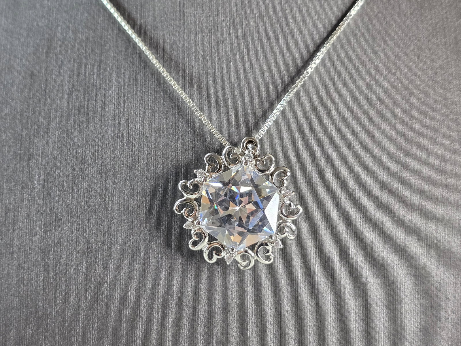 Womens Vintage Estate Sterling Silver CZ Pendant w/ Necklace: A WOMENS VINTAGE ESTATE STERLING SILVER CZ PENDANT WITH NECKLACE. TOGETHER THEY WEIGH 10.3g. THE PENDANT MEASURES 1 1/8" LONG BY 1" WIDE. THE NECKLACE MEASURES 18" LONG. MAKES A GREAT GIFT FOR THAT SO