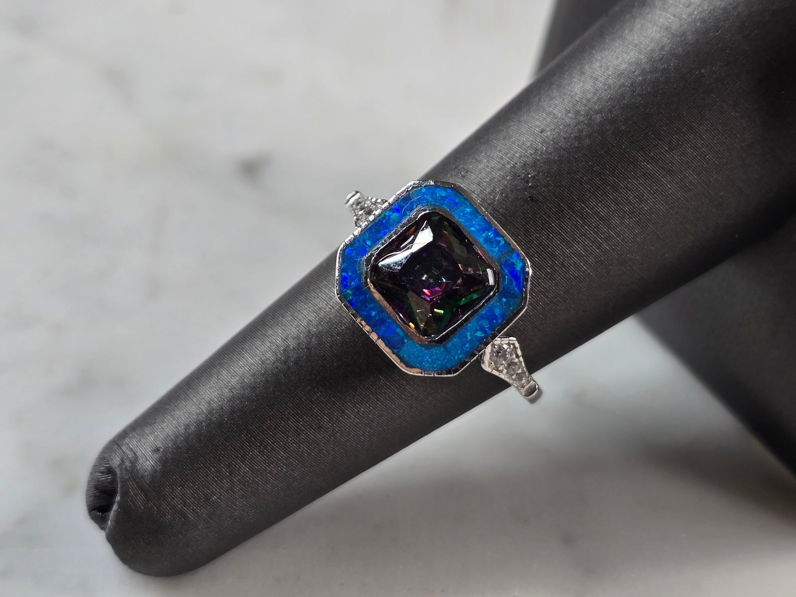 Womens Sterling Silver Modernist Blue Opal Mystic Topaz Ring: A WOMENS STERLING SILVER MODERNIST BLUE OPAL & MYSTIC TOPAZ COLORED RING. THE RING IS A SIZE 6.0, AND WEIGHS 3.9g. WIDTH OF RING MEASURES 1/2". NOT SURE IF STONE IS NATURAL OR MAN MADE. THE RING MAKES