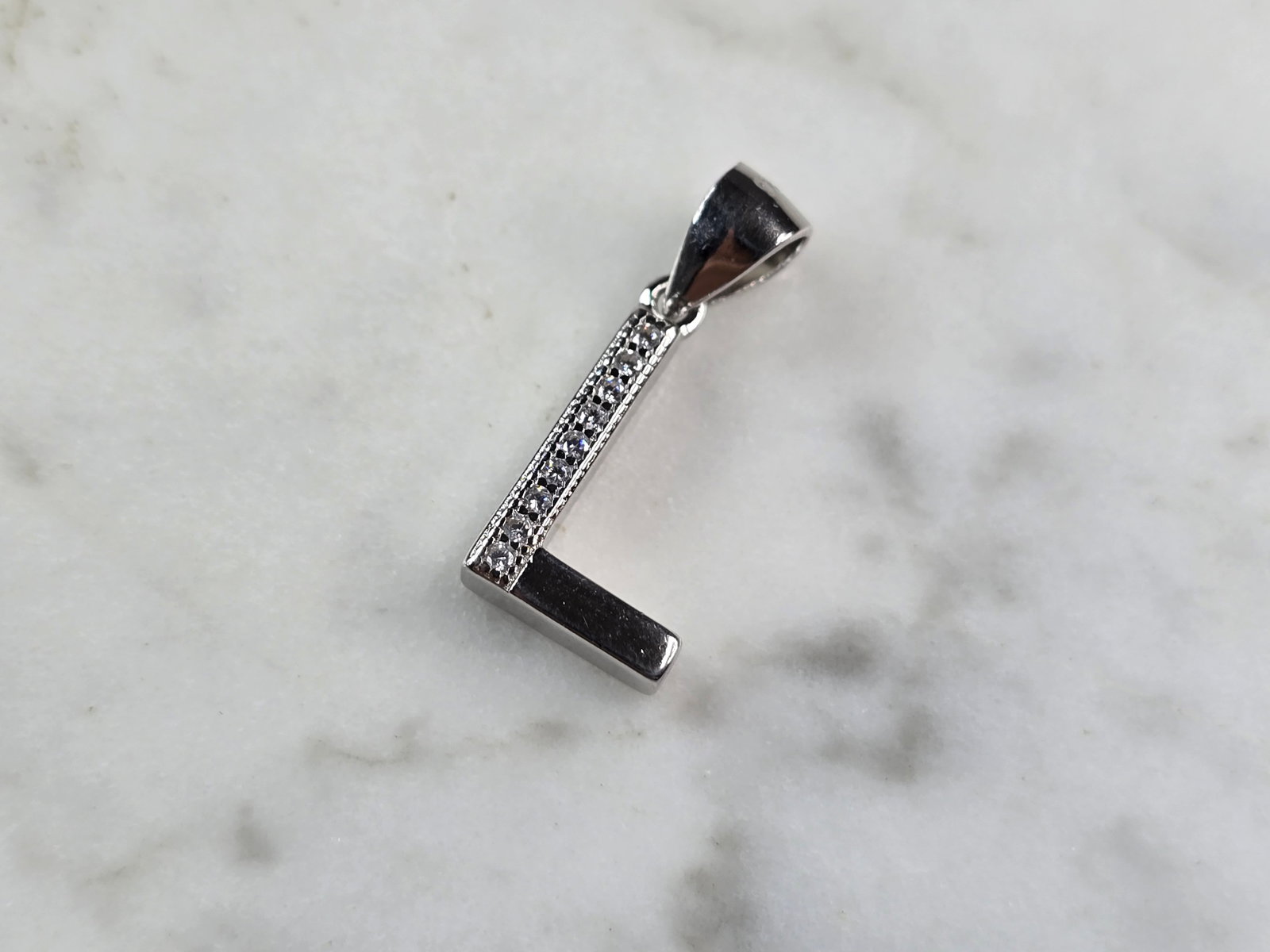 Womens Vintage Estate Sterling Silver CZ Letter "L" Pendant: FOR SALE IS THIS WOMENS VINTAGE ESTATE STERLING SILVER CZ LETTER "L" PENDANT. PENDANT WEIGHS 1.4g AND PENDANT MEASURES 7/8" LONG BY 3/8" WIDE. MAKES A GREAT GIFT FOR THAT SOMEONE SPECIAL. IF ANY QUEST