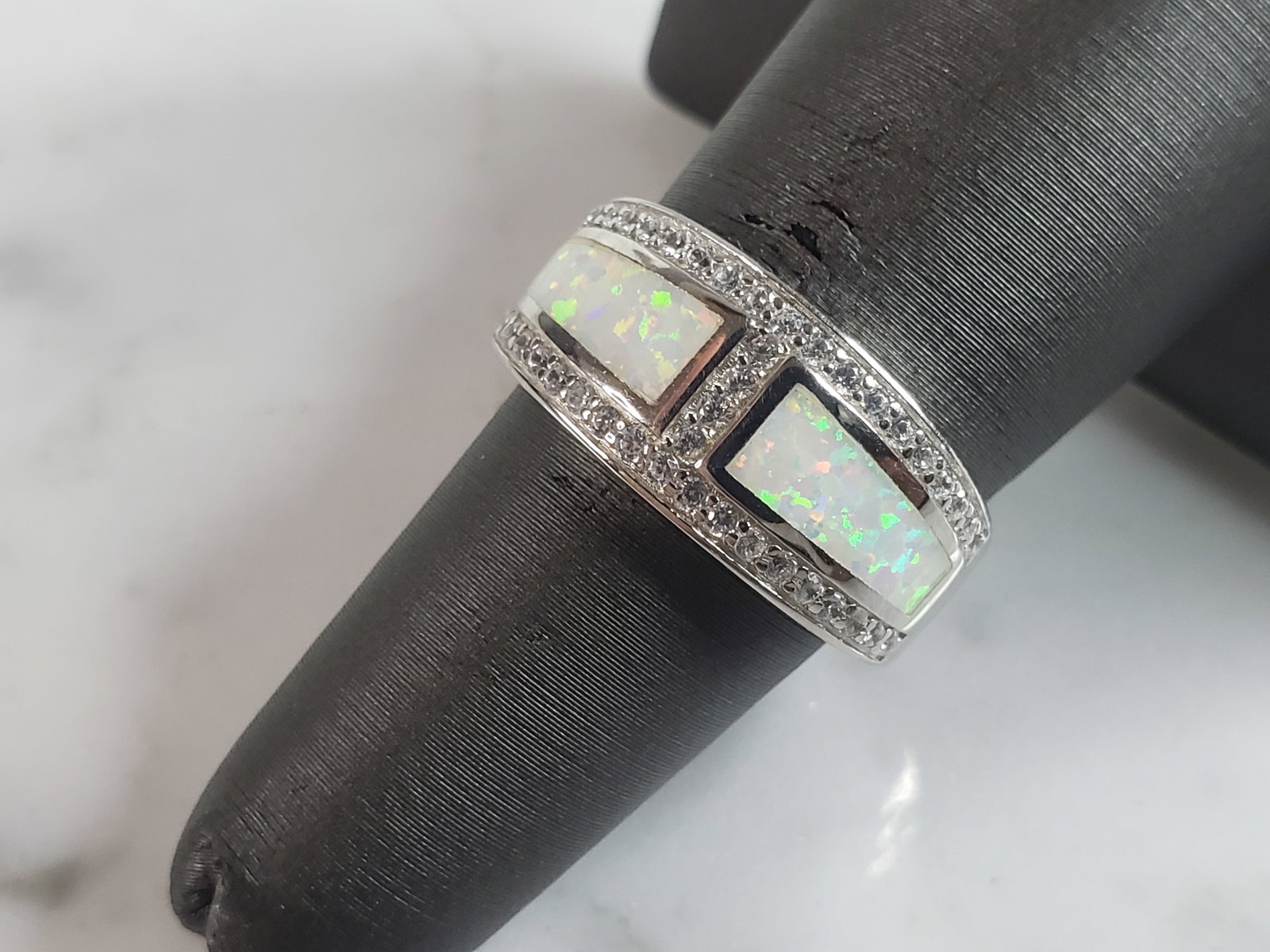 Womens Sterling Silver Modernist Opal Ring: A WOMENS STERLING SILVER MODERNIST OPAL RING. THE RING IS A SIZE 6.0 AND WEIGHS 4.9g. THE WIDTH OF THE RING MEASURES 3/8". RING MAKES A BEAUTIFUL GIFT FOR THAT SOMEONE SPECIAL. ANY QUESTIONS, PLEASE A