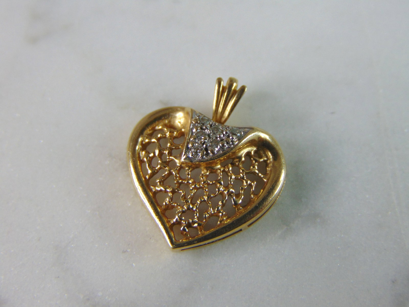 Womens Vintage Estate 14K Yellow Gold Heart Diamond Pendant: A WOMENS VINTAGE ESTATE 14K YELLOW GOLD HEART PENDANT WITH DIAMONDS. PENDANT WEIGHS 1.6g, AND MEASURES 5/8" BY 5/8". THERE ARE ABOUT .06cts OF DIAMONDS IN THIS PENDANT. WOULD MAKE A LOVELY GIFT FOR TH