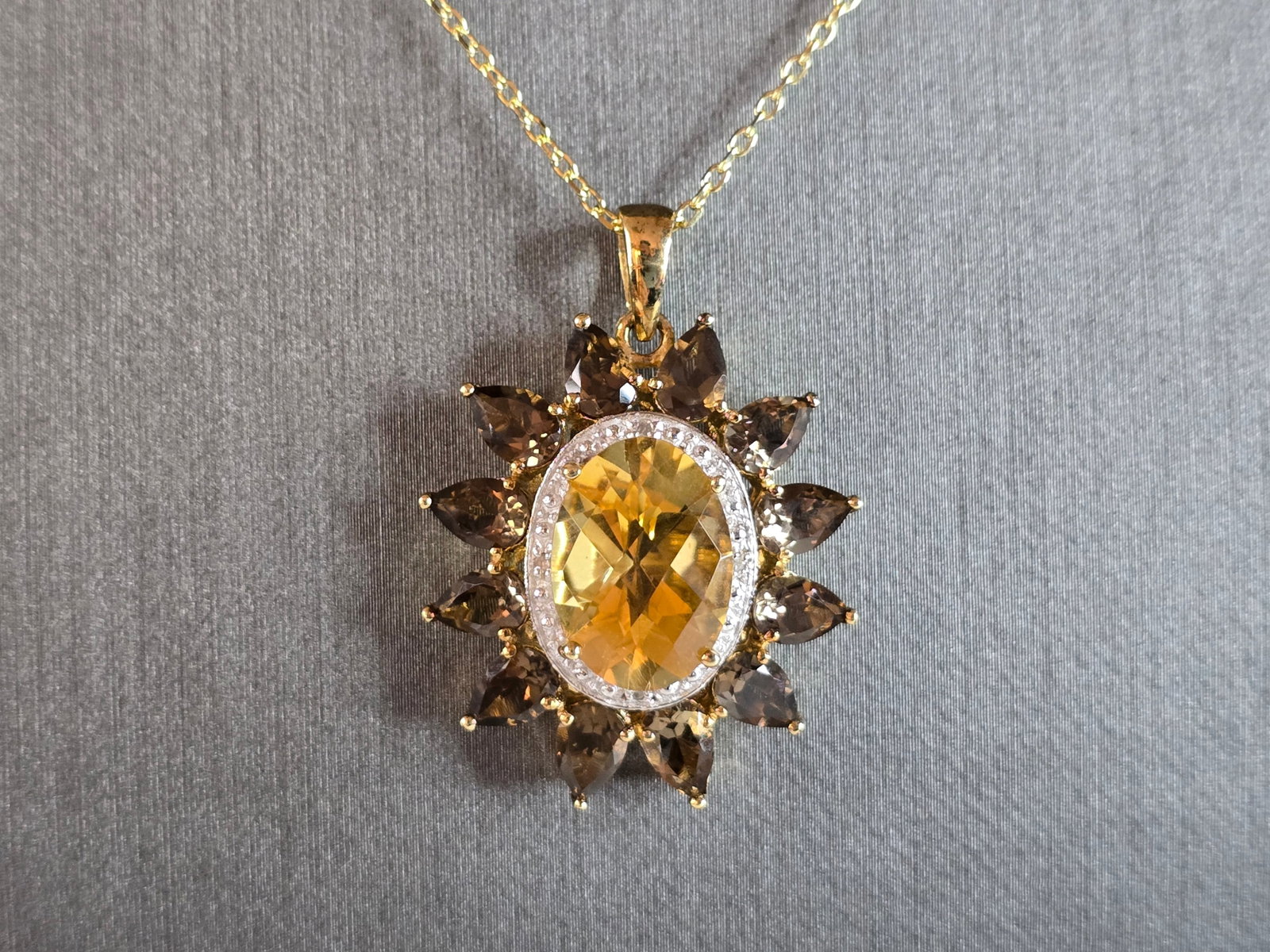 Womens Sterling Silver Necklace w/ Citrine Stone Pendant: A WOMENS VINTAGE ESTATE STERLING SILVER NECKLACE WITH A CITRINE & SMOKY QUARTZ COLORED STONE PENDANT. NOT SURE IF THE STONE IS NATURAL OR MAN MADE. THE PENDANT MEASURES 1 1/4" BY 1". THE NECKLACE MEAS