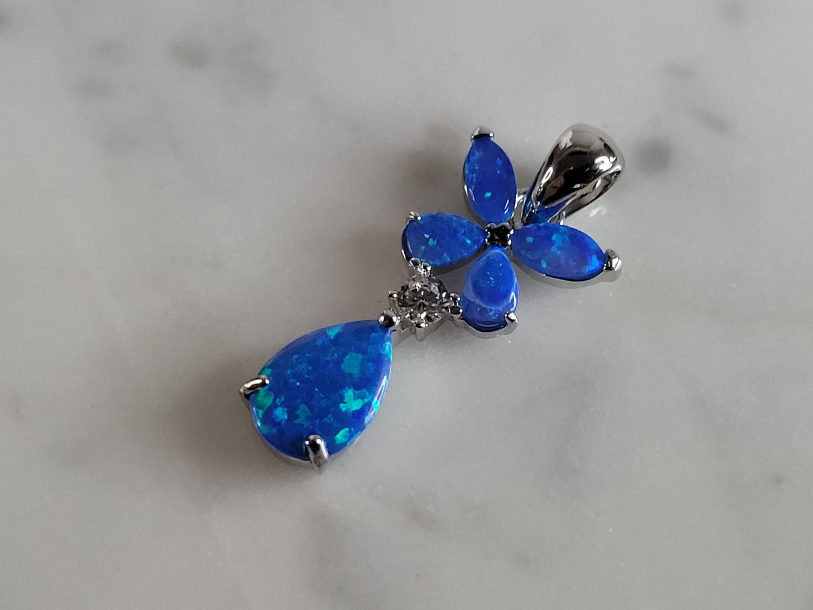 Womens Sterling Silver Blue Opal Butterfly Pendant: A WOMENS STERLING SILVER BLUE OPAL BUTTERFLY PENDANT. NOT SURE IF STONES ARE REAL OR MAN MADE. THE PENDANT WEIGHS 1.3g AND MEASURES 7/8" LONG BY 3/8" WIDE. MAKES A GREAT GIFT FOR THAT SOMEONE SPECIAL.