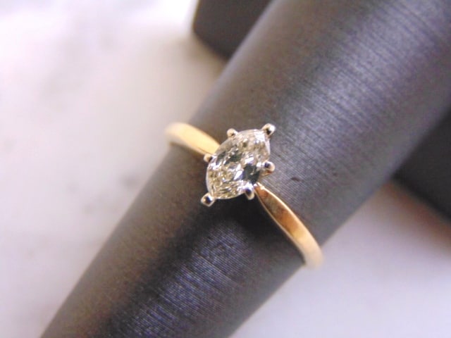 14K Yellow Gold Marquise Diamond Engagement Ring: A BEAUTIFUL VINTAGE 14K GOLD WOMEN'S ENGAGEMENT RING WITH A MARQUIS CUT DIAMOND THAT IS ABOUT .75cts. THE SIZE OF THE RING IS A 6.25, AND WEIGHS 2.1g. NOT SURE OF THE COLOR OR CLARITY OF THE DIAMOND, 