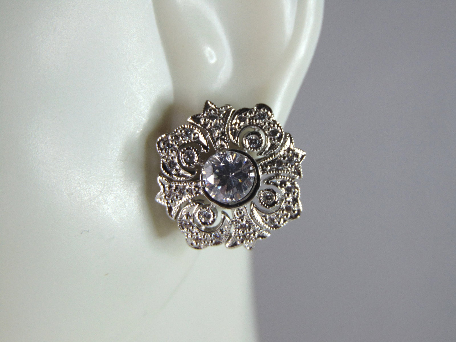 Womens Vintage Estate Sterling Silver CZ Earrings: A PAIR OF WOMENS STERLING SILVER CZ EARRINGS THAT WEIGH 4.1g AND MEASURE 5/8" LONG BY 5/8" WIDE. EARRINGS CAN BE TAKEN APART TO JUST WEAR THE CZ STUD OR PUT TOGETHER. ANY OTHER QUESTIONS, PLEASE DO NO