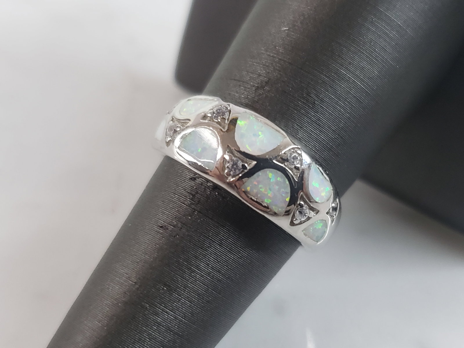 Womens Sterling Silver Modernist Opal Ring: A WOMENS STERLING SILVER MODERNIST OPAL RING. THE RING IS A SIZE 8.0 AND WEIGHS 4.9g. THE WIDTH OF THE RING IS 1/4". THE RING MAKES A BEAUTIFUL GIFT FOR THAT SOMEONE SPECIAL. ANY QUESTIONS, PLEASE ASK
