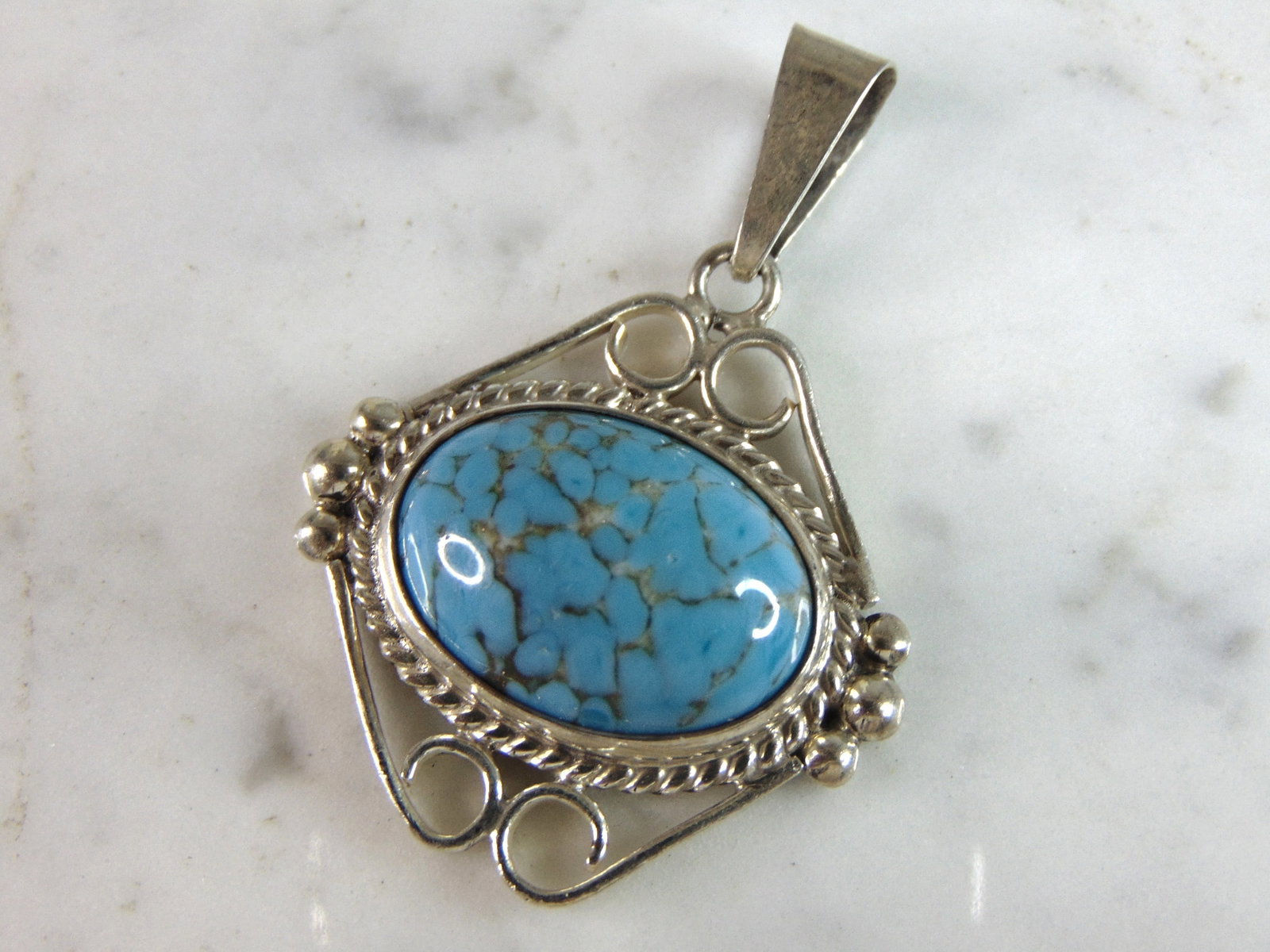 Womens Vintage Estate Sterling Silver Turquoise Pendant: A WOMENS VINTAGE ESTATE STERLING SILVER TURQUOISE PENDANT. NOT SURE IF STONE IS NATURAL OR MAN MADE. PENDANT WEIGHS 18.6g AND MEASURES 2 1/8" LONG BY 1 1/2" WIDE. MAKES A GREAT GIFT FOR THAT SOMEONE S