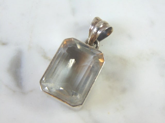 Womens Vintage Estate Sterling Silver CZ Pendant: FOR SALE IS THIS LOVELY VINTAGE STERLING SILVER CZ PENDANT. THE TOTAL WEIGHT IS 13.1g. THE PENDANT MEASURES 1 3/8" WIDE BY 5/8" LONG. MAKES A GREAT GIFT FOR THAT SPECIAL SOMEONE. ANY QUESTIONS, PLEASE