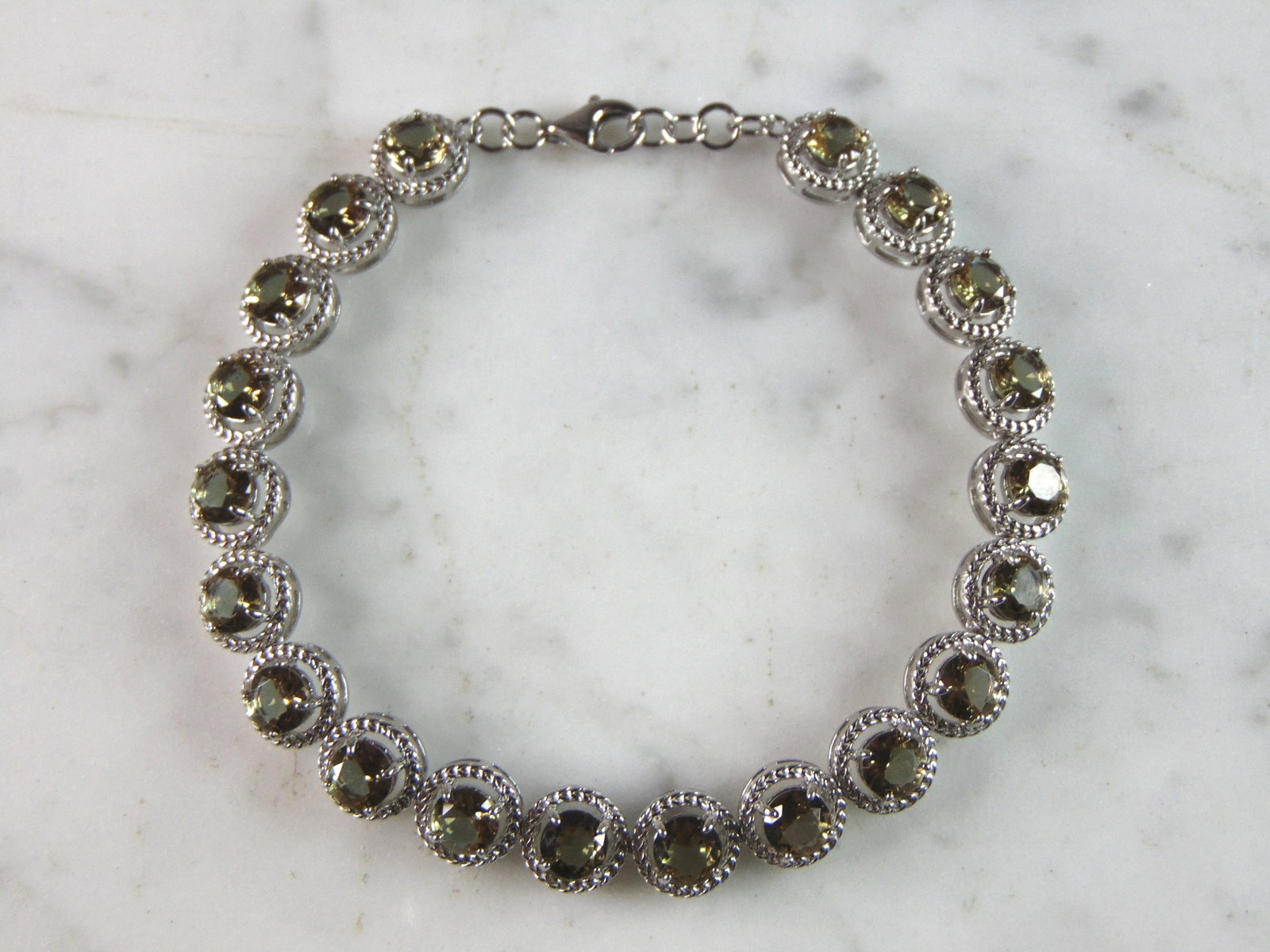 Womens Estate Sterling Silver Modernist Citrine Bracelet: A WOMENS ESTATE STERLING SILVER MODERNIST CITRINE COLORED BRACELET. BRACELET MEASURES 7 1/2" LONG BY 1/4" WIDE AND WEIGHS 13.8g. THIS WOULD MAKE A LOVELY GIFT FOR THAT SOMEONE SPECIAL. ANY QUESTIONS, 