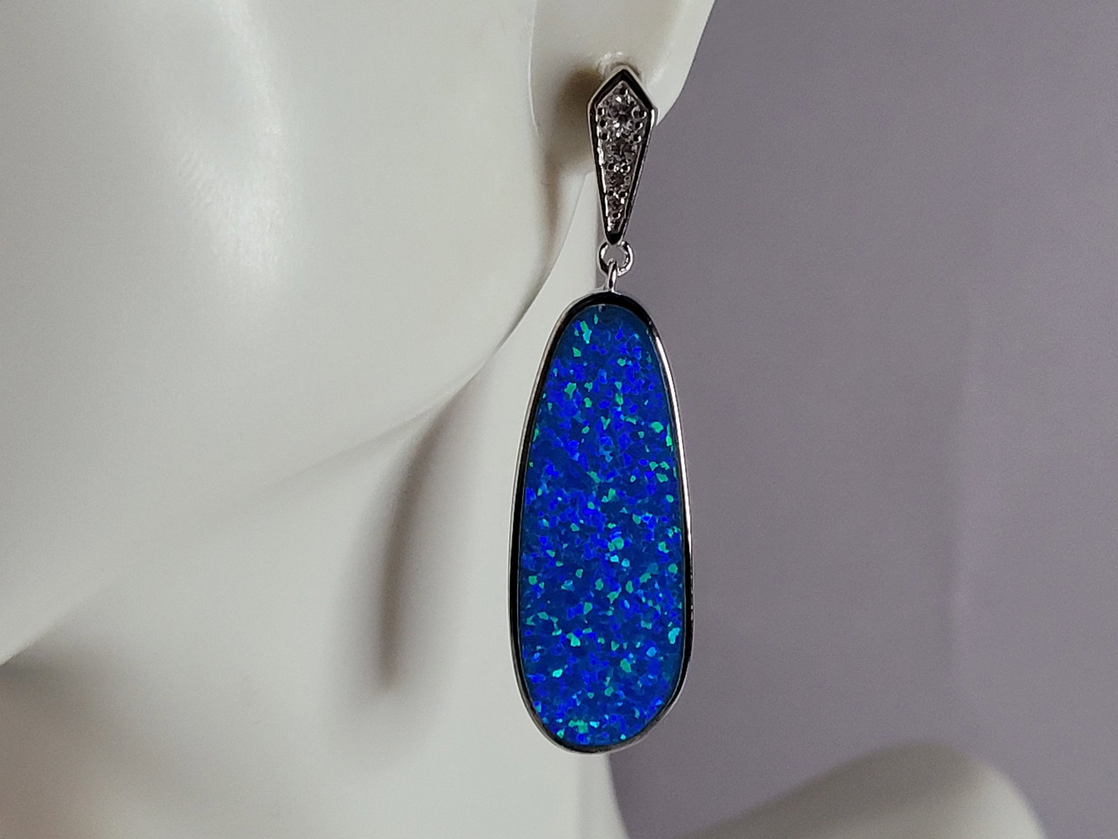 Womens Sterling Silver Blue Opal Modernist Earrings: A WOMENS ESTATE STERLING SILVER BLUE OPAL MODERNIST EARRINGS. NOT SURE IF STONES ARE REAL OR MAN MADE. THE EARRINGS WEIGH 8.8g AND MEASURES 1 5/8" LONG BY 1/2" WIDE. MAKES A GREAT GIFT FOR THAT SOMEON