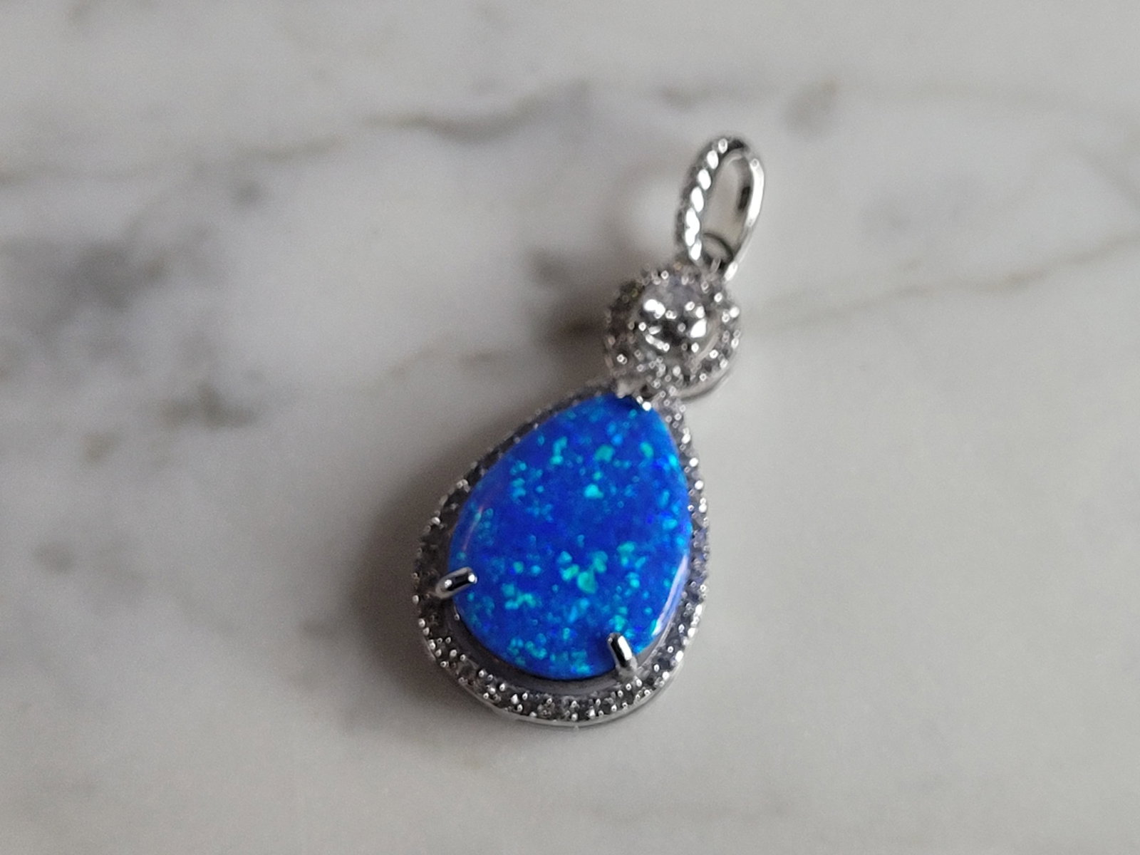 Womens Sterling Silver Blue Opal Modernist Pendant: A WOMENS ESTATE STERLING SILVER BLUE OPAL MODERNIST PENDANT. NOT SURE IF STONES ARE REAL OR MAN MADE. THE PENDANT WEIGHS 2.8g AND MEASURES 1 3/8" LONG BY 5/8" WIDE. MAKES A GREAT GIFT FOR THAT SOMEONE