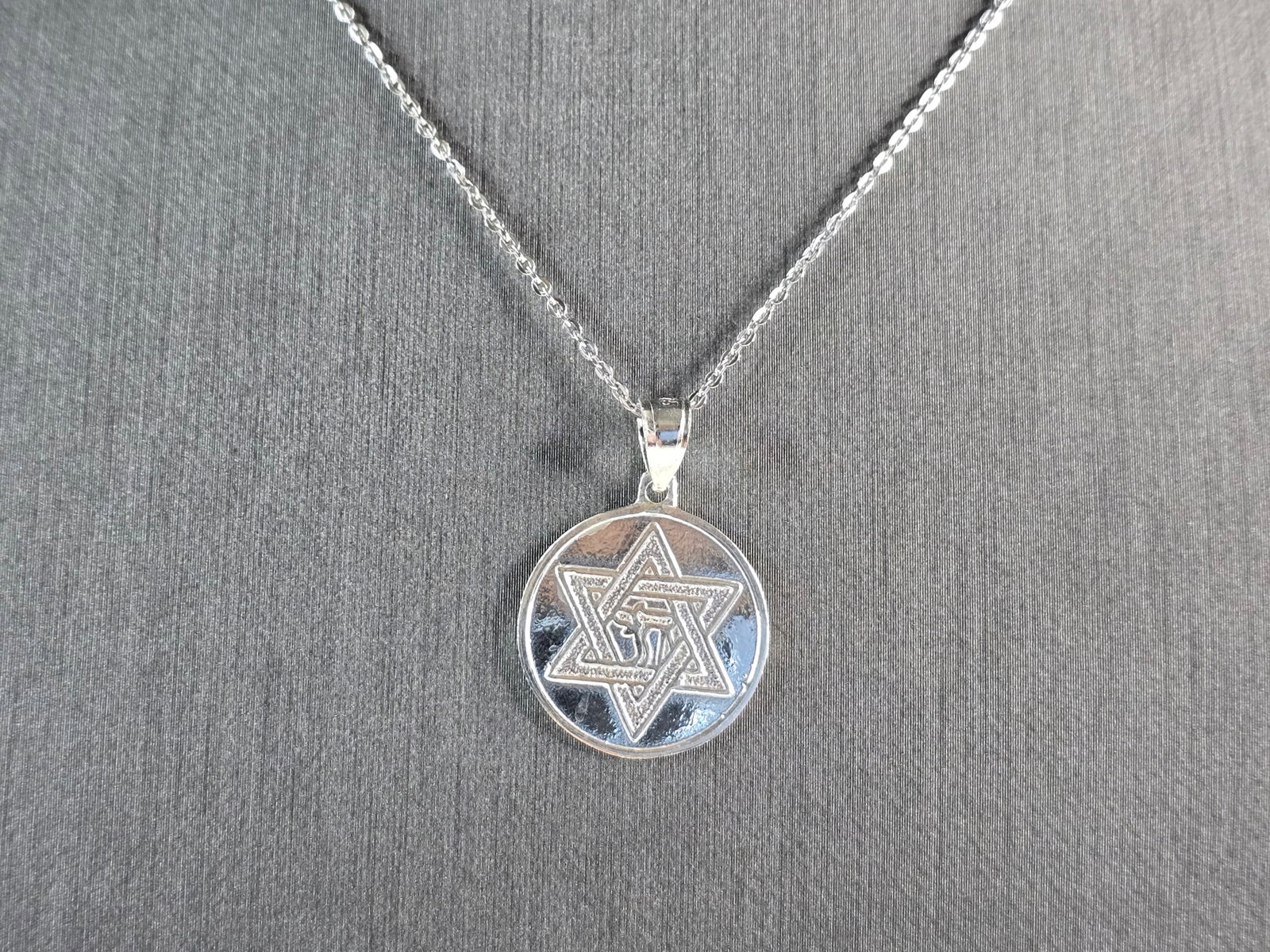 Sterling Silver Jewish Judaica Star of David Pendant Necklace: A STERLING SILVER STAR OF DAVID PENDANT WITH NECKLACE. THE PENDANT WITH NECKLACE WEIGHS 4.3g. PENDANT MEASURES 1" LONG BY 3/4" WIDE. THE NECKLACE MEASURES 18" LONG AND IS ADJUSTABLE TO 16". MAKES A GR