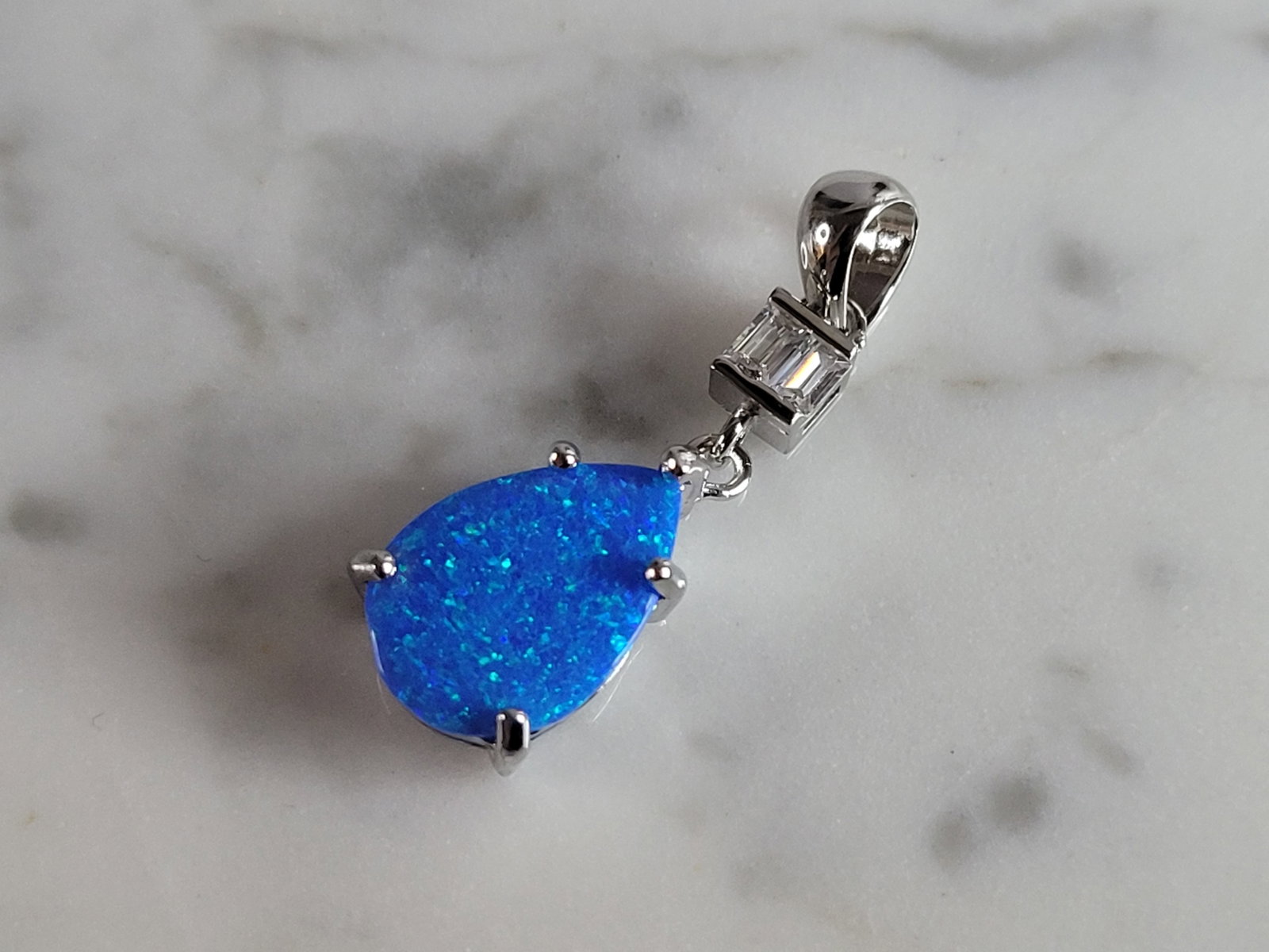 Womens Sterling Silver Blue Opal Modernist Pendant: A WOMENS STERLING SILVER BLUE OPAL MODERNIST PENDANT. NOT SURE IF STONES ARE REAL OR MAN MADE. THE PENDANT WEIGHS 1.7g AND MEASURES 1" LONG BY 3/8" WIDE. MAKES A GREAT GIFT FOR THAT SOMEONE SPECIAL. A