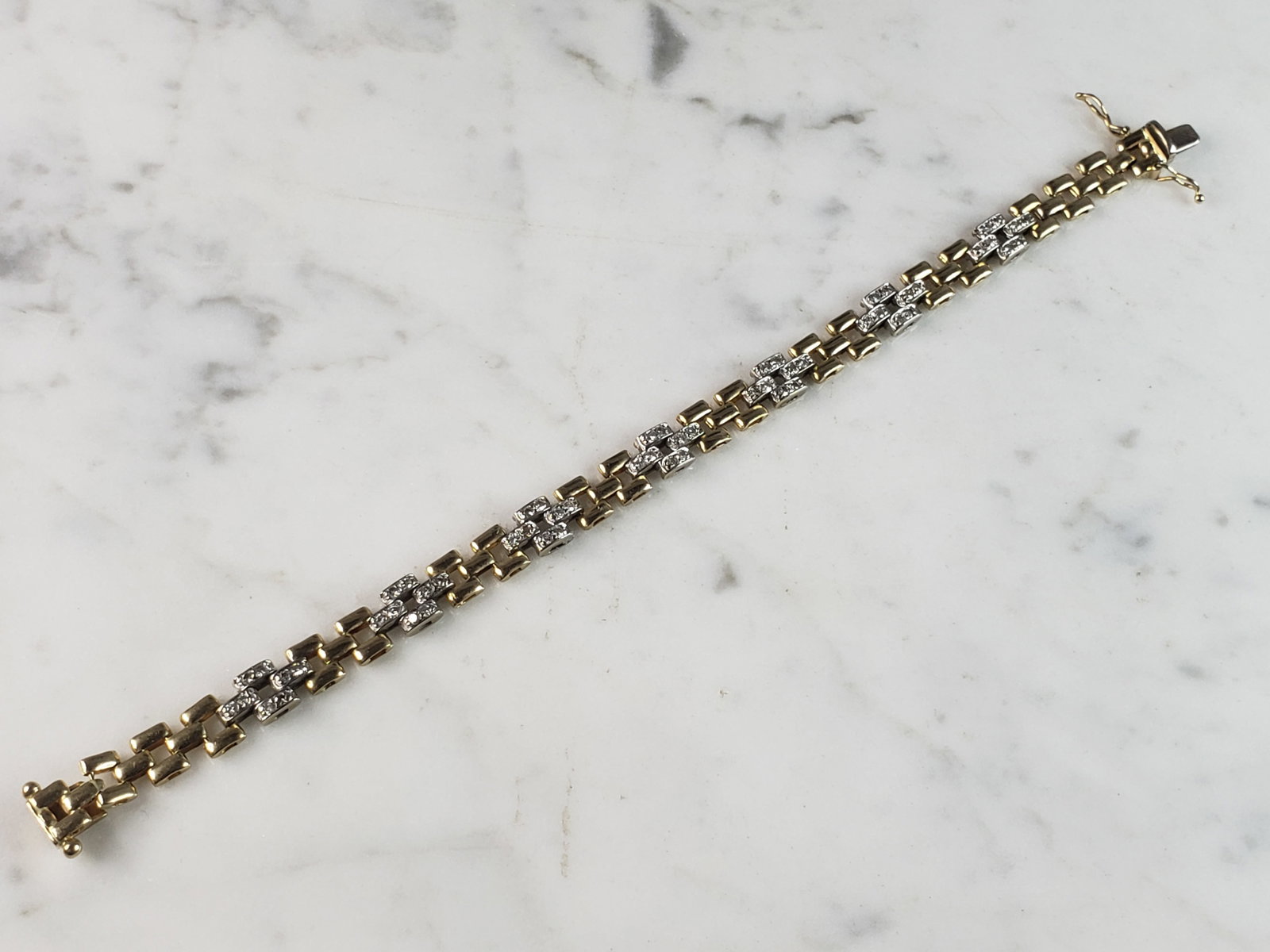 Womens Vintage Estate 14K Gold Diamond Bracelet: A WOMENS VINTAGE ESTATE 14K YELLOW & WHITE GOLD DIAMOND BRACELET THAT MEASURES 7 1/8" LONG BY ABOUT 1/4" WIDE, AND WEIGHS 15.5g. THERE ARE ABOUT .56cts OF DIAMONDS. THIS WOULD MAKE A LOVELY GIFT FOR T