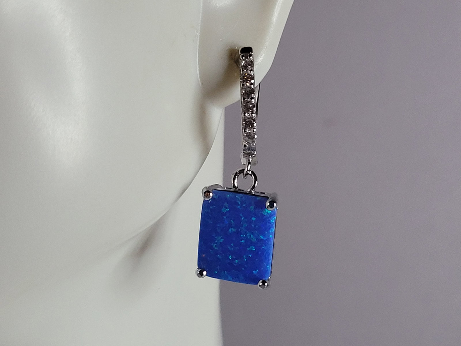 Womens Sterling Silver Modernist Blue Opal Earrings: A PAIR OF WOMENS STERLING SILVER MODERNIST BLUE OPAL COLORED EARRINGS THAT WEIGH 4.5g AND MEASURES 1 1/8" LONG BY 3/8" WIDE. NOT SURE IF STONES ARE REAL OR MAN MADE. ANY QUESTIONS, PLEASE DO NOT HESIT