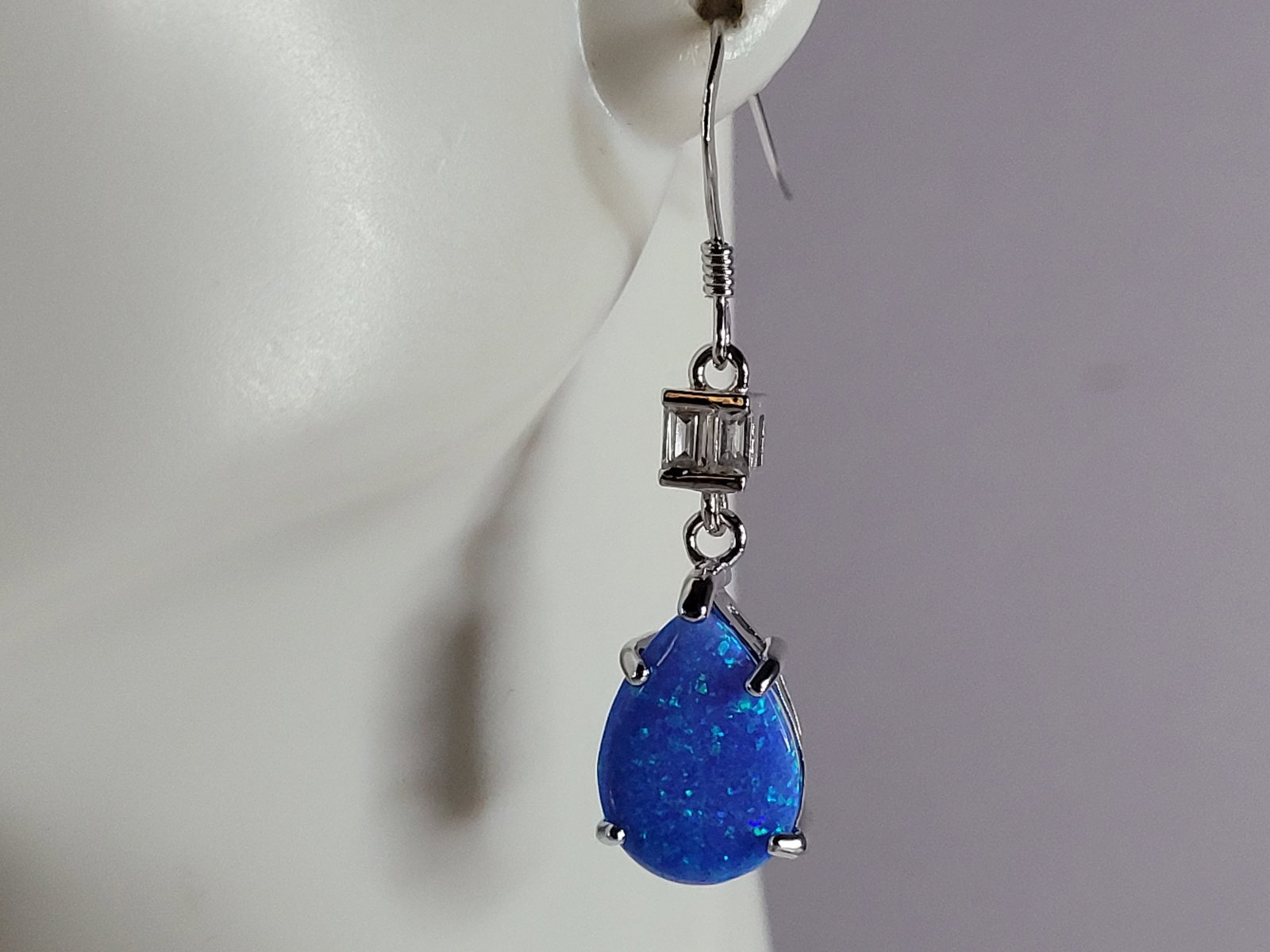 Womens Sterling Silver Modernist Blue Opal Earrings: A PAIR OF WOMENS STERLING SILVER MODERNIST BLUE OPAL COLORED EARRINGS THAT WEIGH 3.4g AND MEASURES 1 3/8" LONG BY 3/8" WIDE. NOT SURE IF STONES ARE REAL OR MAN MADE. ANY QUESTIONS, PLEASE DO NOT HESIT