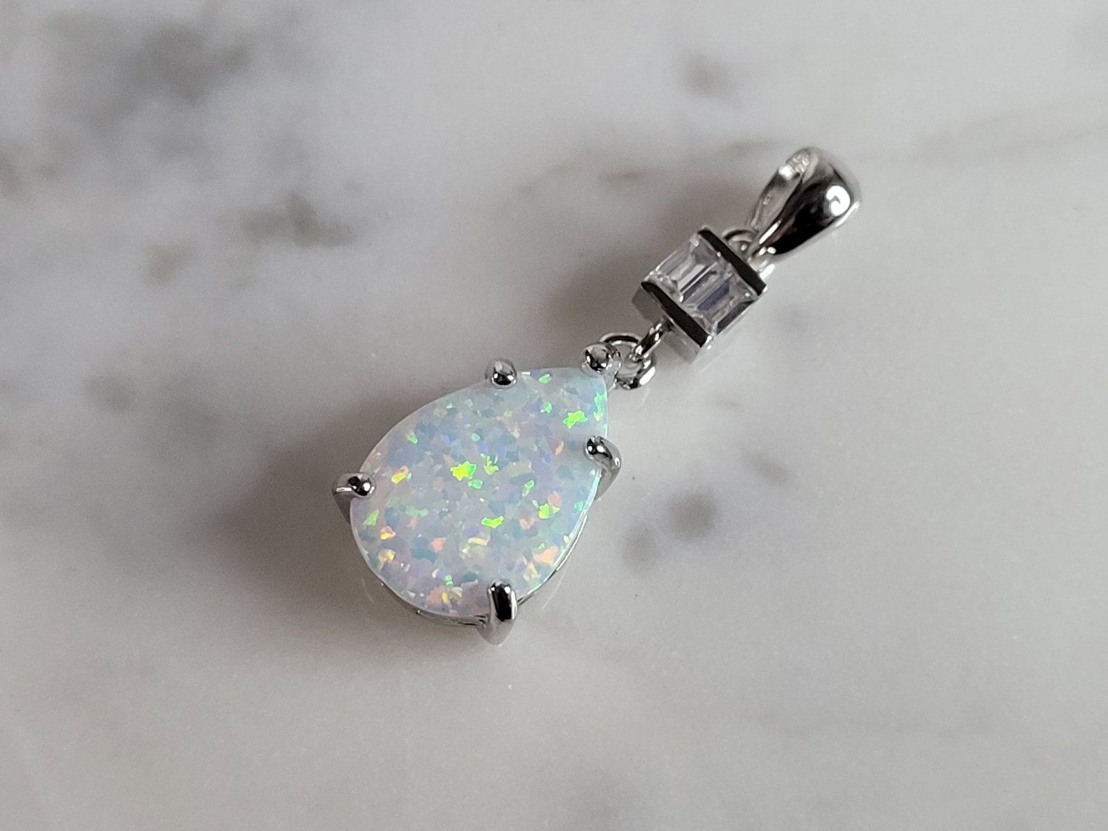 Womens Sterling Silver Modernist Opal Stone Pendant: A WOMENS STERLING SILVER MODERNIST OPAL STONE PENDANT. NOT SURE IF STONES ARE REAL OR MAN MADE. THE PENDANT WEIGHS 1.8g AND MEASURES 1 1/8" LONG BY 3/8" WIDE. MAKES A GREAT GIFT FOR THAT SOMEONE SPECI