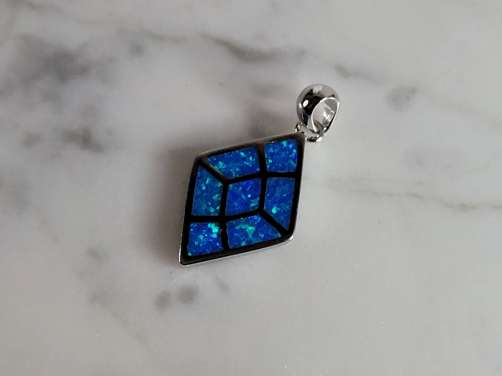 Womens Sterling Silver Modernist Blue Opal Pendant: WOMENS STERLING SILVER MODERNIST BLUE OPAL COLORED PENDANT WEIGHES 3.2g, AND MEASURES 1 1/8" LONG BY 5/8" WIDE. NOT SURE IF STONES ARE REAL OR MAN MADE. ANY QUESTIONS, PLEASE DO NOT HESITATE TO ASK. B