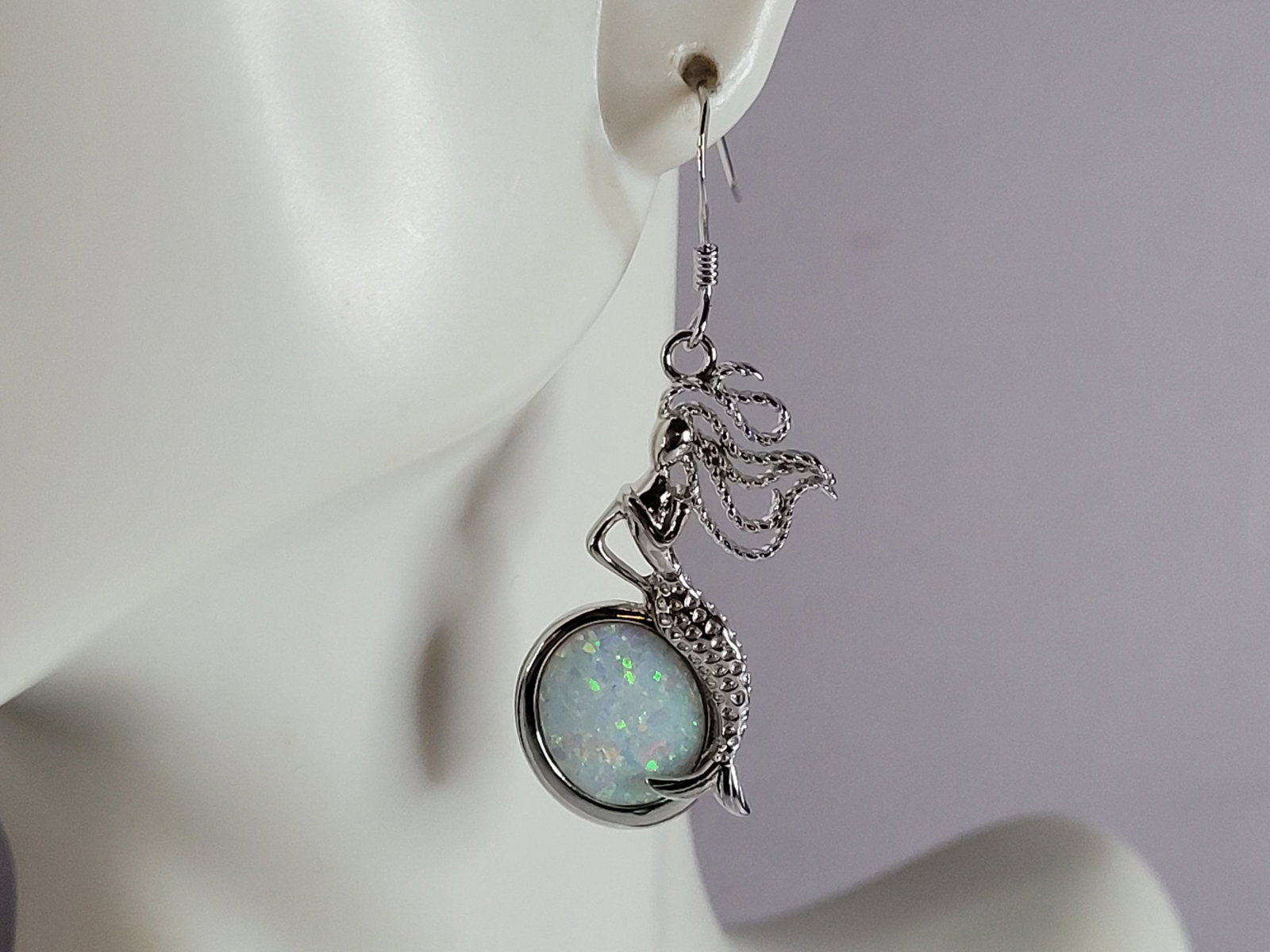 Womens Sterling Silver Modernist Opal Mermaid Earrings: A PAIR OF WOMENS STERLING SILVER OPAL COLORED MERMAID EARRINGS THAT WEIGH 8.5g AND MEASURES 1 3/4" LONG BY 1/2" WIDE. NOT SURE IF STONES ARE REAL OR MAN MADE. ANY QUESTIONS, PLEASE DO NOT HESITATE TO 