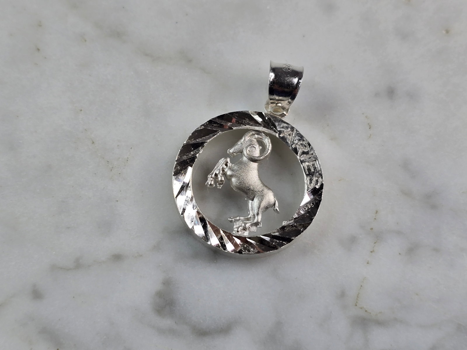 Womens Vintage Estate Sterling Silver Zodiac Aries Pendant: A WOMENS VINTAGE ESTATE STERLING SILVER ZODIAC ARIES PENDANT. THE PENDANT WEIGHS 4.1g, AND MEASURES 1 1/4" LONG BY 3/4" WIDE. PENDANT IS MARKED ON THE BALE. MAKES A GREAT GIFT FOR THAT SOMEONE SPECIAL