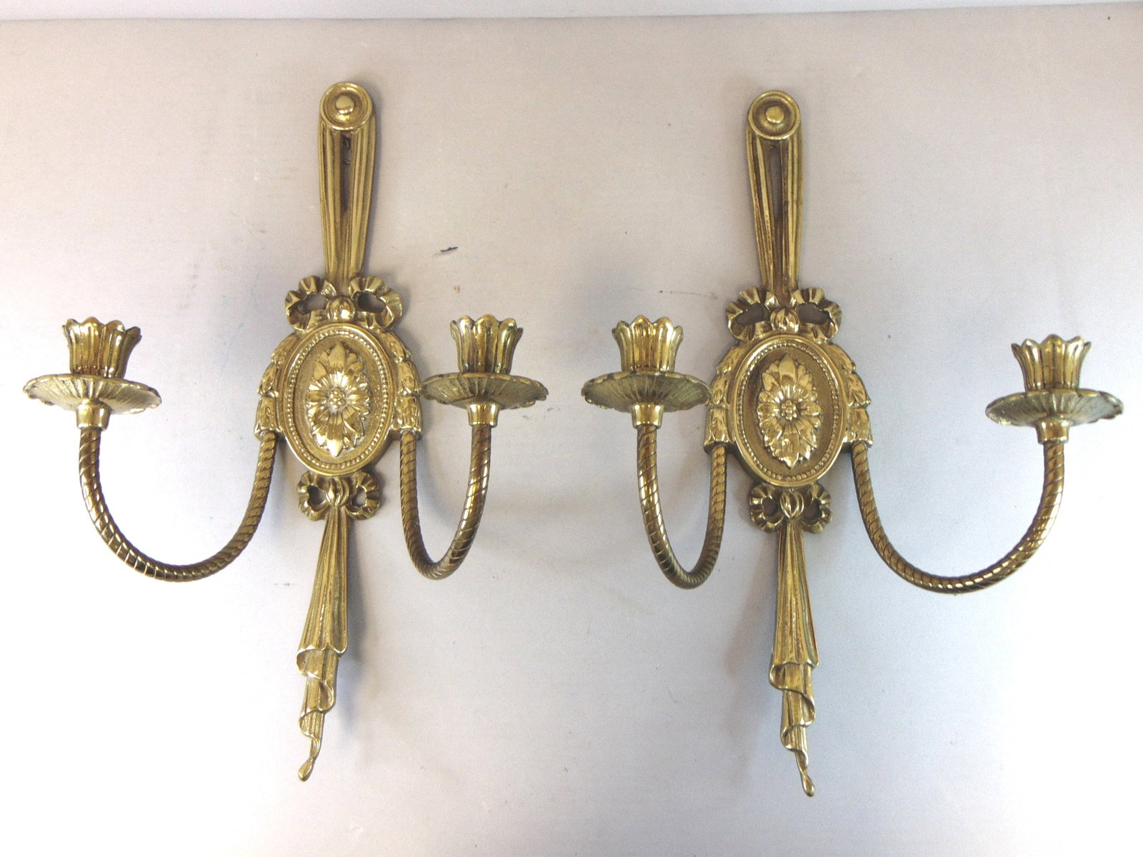 Pair of Vintage Estate Brass Wall Candleholder Sconces: A BEAUTIFUL PAIR OF VINTAGE ESTATE BRASS WALL CANDLEHOLDER SCONCES. EACH SCONCE MEASURES ABOUT 16" LONG, BY ABOUT 10 1/2" WIDE, AND STICKS OUT ABOUT 5 7/8" FROM THE WALL. WOULD MAKE A GREAT ADDITION T