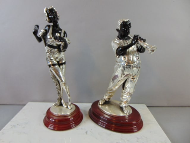 VINTAGE SET OF BLACK AMERICANA MUSICIAN STATUES: A vintage set of black americana musician statues. They range from about 12 1/4" tall to 13 1/2" tall. They appear to be made of silverplate but not 100%. Still a nice decorative set of statues.