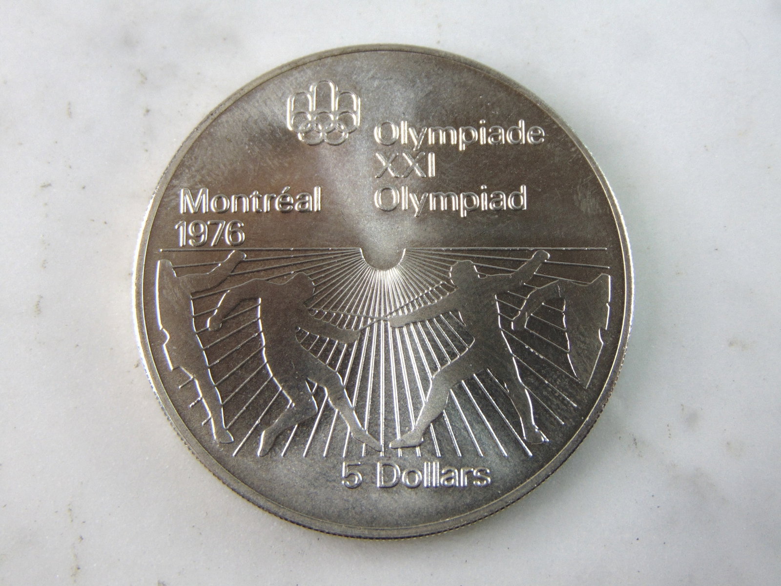 1976 $5 Canadian '76 Montreal Summer Olympics Silver Coin: FOR SALE IS THIS 1976 $5 CANADIAN '76 MONTREAL SUMMER OLYMPICS SILVER COIN. COIN APPEARS TO BE IN VERY GOOD CONDITION, UNC , HOWEVER WE ARE NOT COIN EXPERTS WHEN IT COMES TO PROPER GRADING. PICTURES S