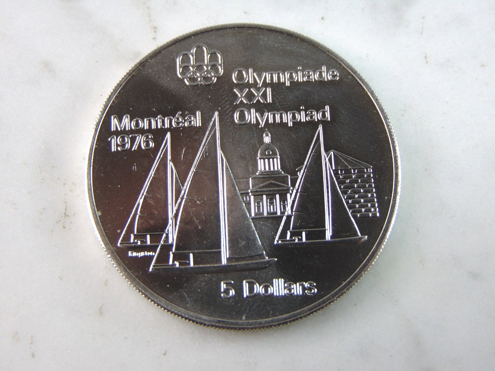 1973 $5 Canadian '76 Montreal Summer Olympics Silver Coin: FOR SALE IS THIS 1973 $5 CANADIAN '76 MONTREAL SUMMER OLYMPICS SILVER COIN. COIN WEIGHS 24.2g. COIN APPEARS TO BE IN VERY GOOD CONDITION, UNC , HOWEVER WE ARE NOT COIN EXPERTS WHEN IT COMES TO PROPER