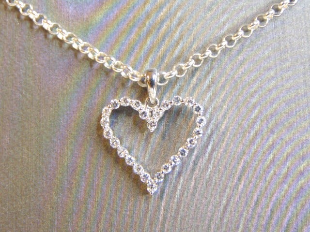 Womens Sterling Silver Heart CZ Pendant W/ Necklace: A WOMENS VINTAGE ESTATE STERLING SILVER HEART CZ STONE PENDANT WITH NECKLACE. TOGETHER THEY WEIGH 6.6g. PENDANT MEASURES 3/4" LONG BY 3/4" WIDE. NECKLACE MEASURES 22". MAKES A GREAT GIFT FOR THAT SOME