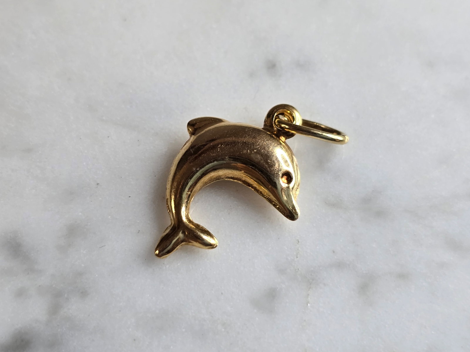 Womens Vintage Estate 14K Yellow Gold Dolphin Pendant: A WOMENS VINTAGE ESTATE 14K YELLOW GOLD DOLPHIN CHARM. CHARM WEIGHS 1.1g, AND MEASURES 3/4" WIDE BY 1/2" LONG. CHARM IS MARKED BUT IT IS HARD TO MAKE OUT. ANY QUESTIONS, PLEASE DO NOT HESITATE TO ASK.