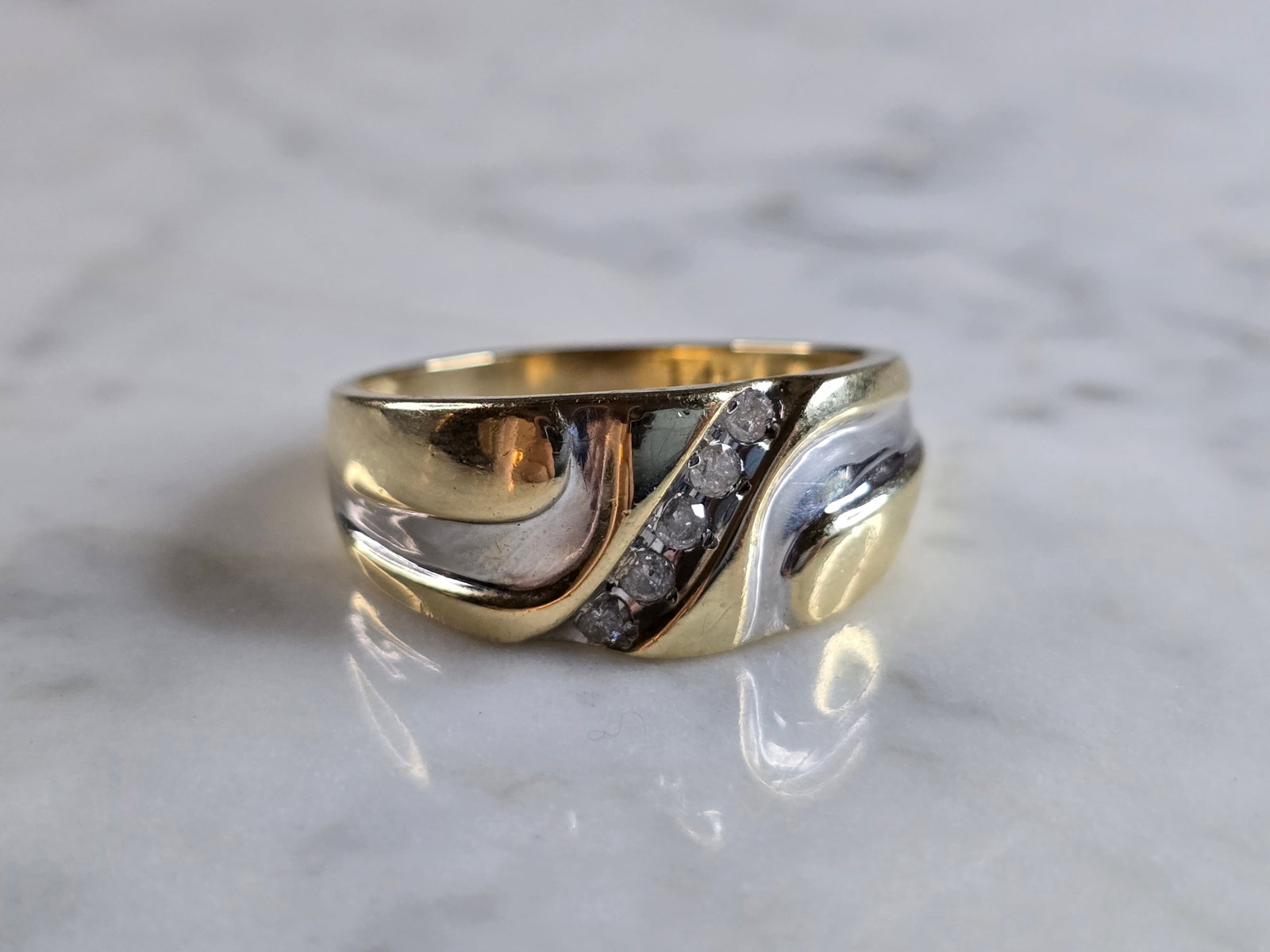 Mens Vintage Estate 14K Yellow & White Gold Diamond Ring: A MEN'S 14K YELLOW & WHITE GOLD DIAMOND RING. THE RING WEIGHS 6.9g. THE SIZE OF THE RING IS A 13.25. THERE ARE ABOUT .15cts OF DIAMONDS IN THIS RING. THE WIDTH OF THE RING IS 3/8". ANY QUESTIONS PLEAS