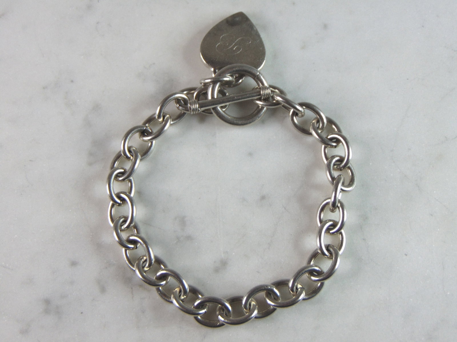 Womens Vintage Estate Sterling Silver Charm Bracelet: A WOMENS VINTAGE ESTATE STERLING SILVER CHARM BRACELET. BRACELET IS 7 5/8" LONG BY 3/8" WIDE, AND WEIGHS 32.0g. THIS WOULD MAKE A LOVELY GIFT FOR THAT SOMEONE SPECIAL. BE SURE TO CHECK OUT SOME OF MY 