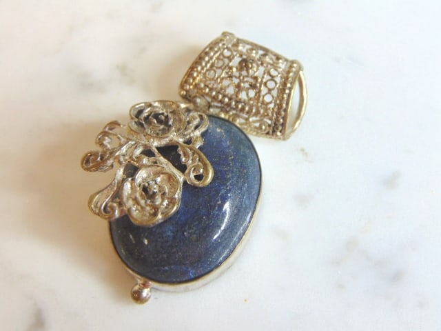 Womens Vintage Sterling Silver Lapis Lazuli Pendant: A WOMENS VINTAGE ESTATE STERLING SILVER LAPIS LAZULI PENDANT. NOT SURE IF STONE IS REAL OR MAN MADE. PENDANT WEIGHS 15.3g AND MEASURES 1 7/8" LONG BY 1" WIDE. MAKES A GREAT GIFT FOR THAT SOMEONE SPECI