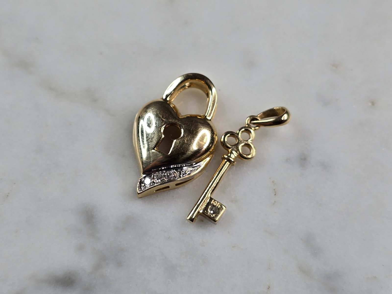 Womens Vintage Estate 14k Gold Diamond Key to Heart Pendant Charms: A WOMENS VINTAGE ESTATE 14K GOLD KEY & HEART PENDANT OR CHARMS. THE HEART MEASURES 3/4" LONG BY 1/2" WIDE, AND THE KEY MEASURES 7/8" BY 3/16", TOGETHER THEY WEIGH 3.6g. THERE ARE 4 TINY DIAMONDS IN TH