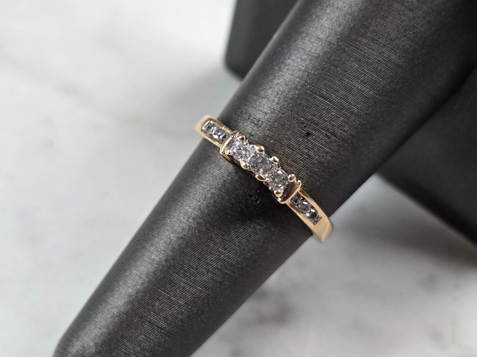 Womens Vintage Estate 10K Yellow Gold Diamond Ring: A WOMENS VINTAGE ESTATE 10K YELLOW GOLD DIAMOND RING WITH A TOTAL OF ABOUT .25cts OF DIAMONDS. THE TOTAL WEIGHT IS 2.0g, AND IS A SIZE 7.25. THE WIDTH OF THE RING IS ABOUT 1/8". RING IS MARKED 10k ON 
