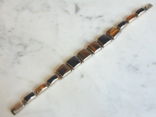 Womens Sterling Silver Tiger Eye & Onyx Bracelet: A LOVELY VINTAGE ESTATE STERLING SILVER TIGER EYE AND ONYX BRACELET. NOT SURE IF STONES ARE REAL OR MAN MADE. BRACELET MEASURES 7 5/8" LONG BY 1/2" WIDE AND WEIGHS 33.5g. THIS WOULD MAKE A LOVELY GIFT