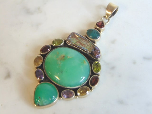 Womens Vintage Sterling Silver Multi Stone Pendant: A WOMENS VINTAGE ESTATE STERLING SILVER MULTI STONE PENDANT. NOT SURE IF STONES ARE REAL OR MAN MADE. PENDANT WEIGHS 18.9g AND PENDANT MEASURES 2 7/8" LONG BY 1 3/8" WIDE. MAKES A GREAT GIFT FOR THAT 