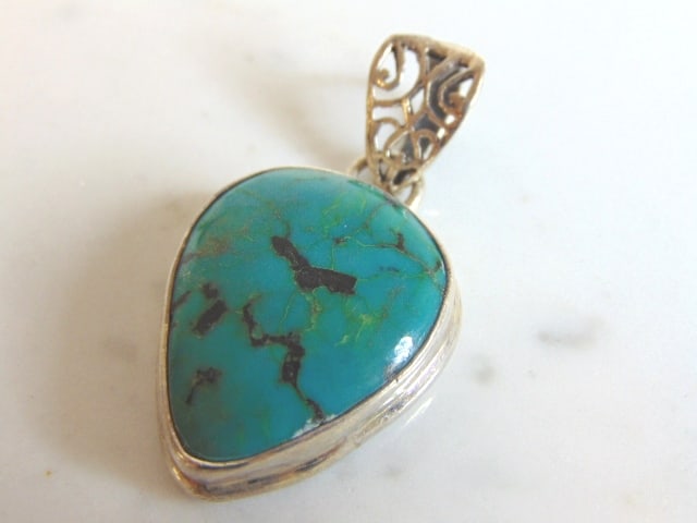 Womens Vintage Estate Sterling Silver Turquoise Pendant: A WOMENS VINTAGE ESTATE STERLING SILVER TURQUOISE PENDANT. NOT SURE IF STONE IS REAL OR MAN MADE. PENDANT WEIGHS 13.6g AND PENDANT MEASURES 1 7/8" LONG BY 7/8" WIDE. MAKES A GREAT GIFT FOR THAT SOMEON
