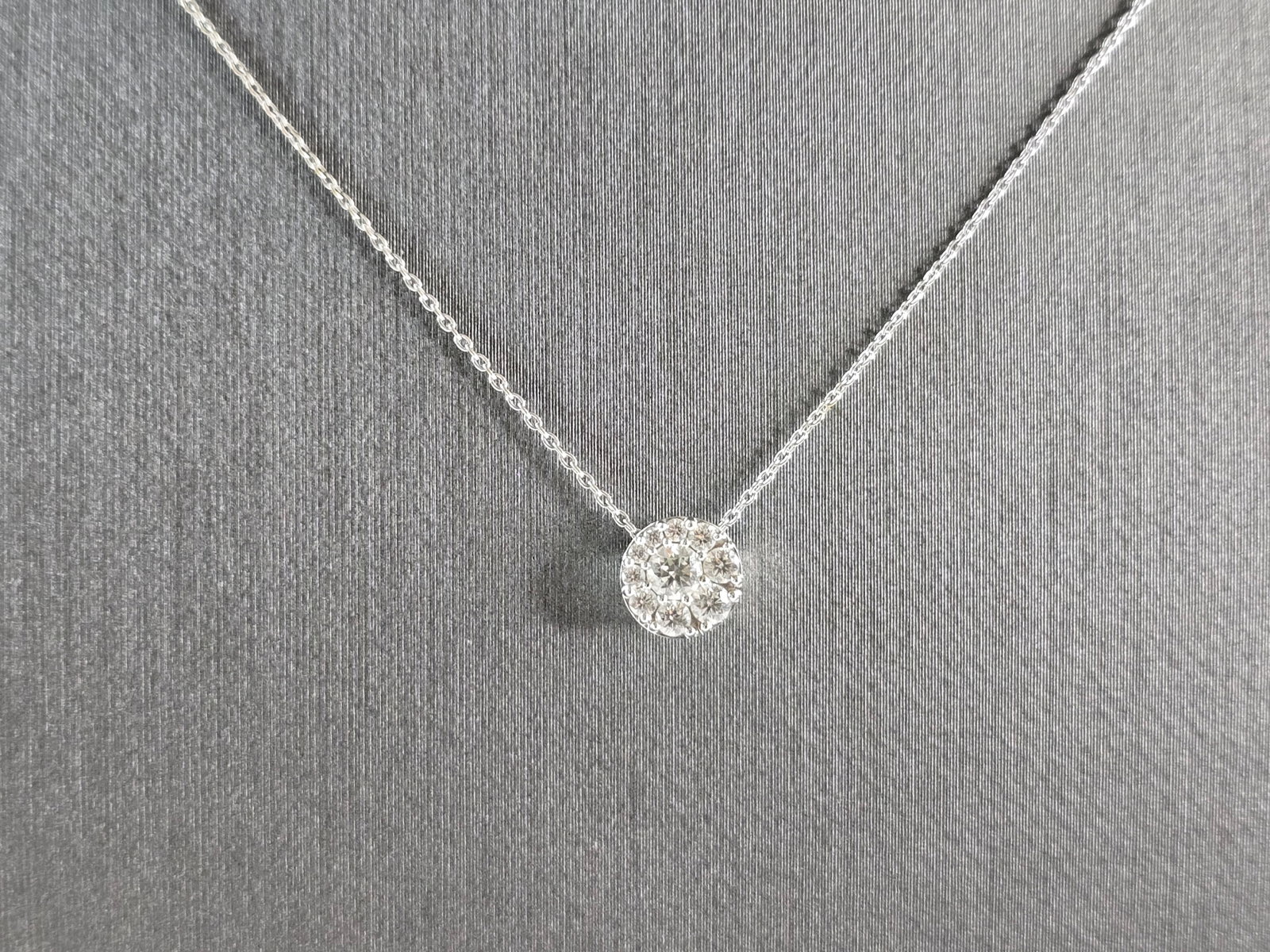 Womens Vintage Estate 18K White Gold Diamond Pendant Necklace: A WOMENS VINTAGE ESTATE 18K WHITE GOLD DIAMOND PENDANT NECKLACE. THE TOTAL WEIGHT IS 2.2g. NECKLACE MEASURES 18" LONG, AND THE PENDANT MEASURES 1/4". THE CENTER DIAMOND IS ABOUT .10cts, WITH 9 TINY AC
