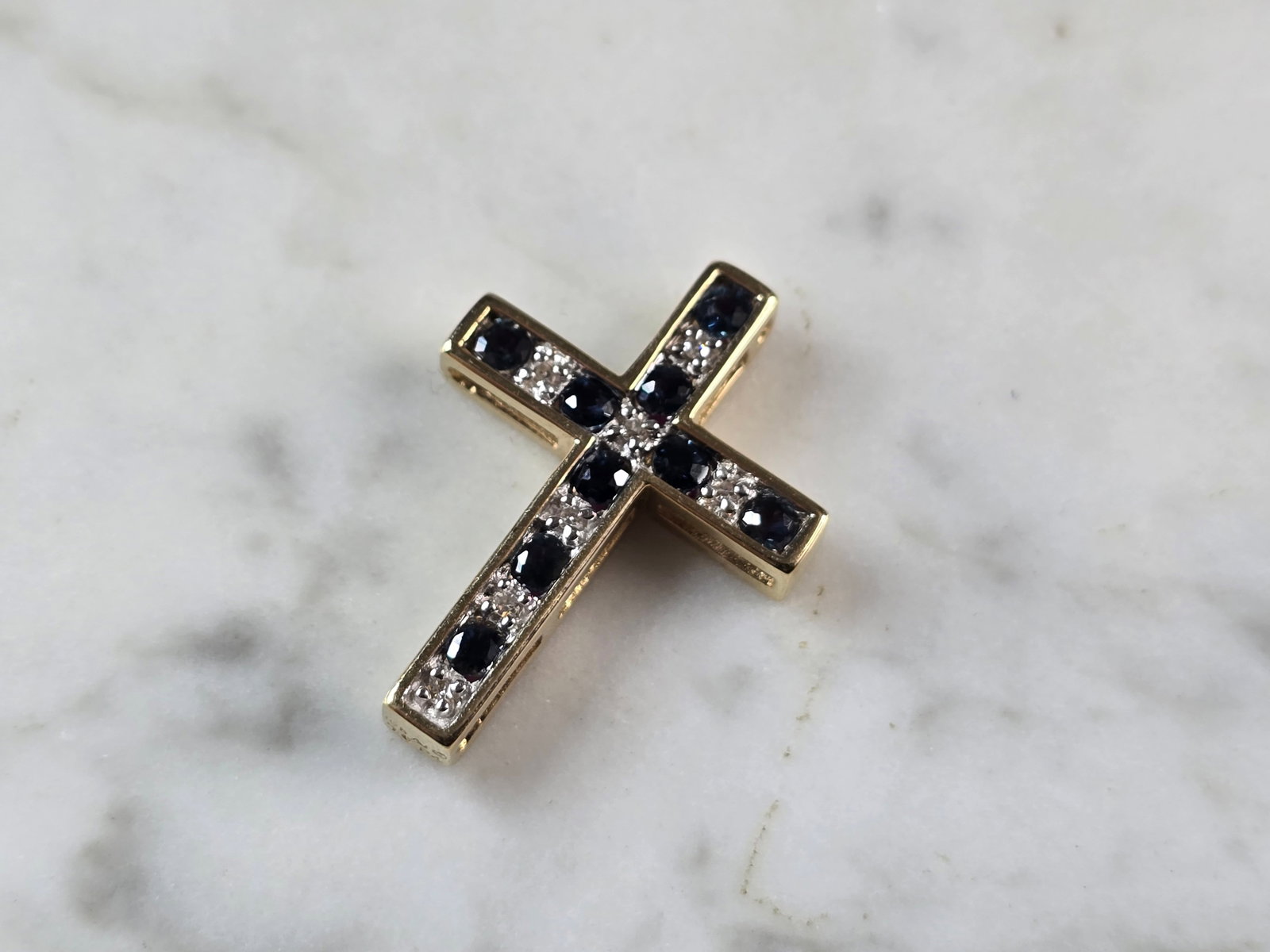 Womens 10K Gold Sapphire Ruby Diamond Reversible Cross Pendant: A WOMENS VINTAGE ESTATE 10K YELLOW GOLD SAPPHIRE, RUBY & DIAMOND REVERSIBLE RELIGIOUS CROSS PENDANT. THE PENDANT WEIGHS 3.3g AND MEASURES 1" LONG BY 3/4" WIDE. PENDANT IS MARKED "10k". THERE ARE 9 SMA