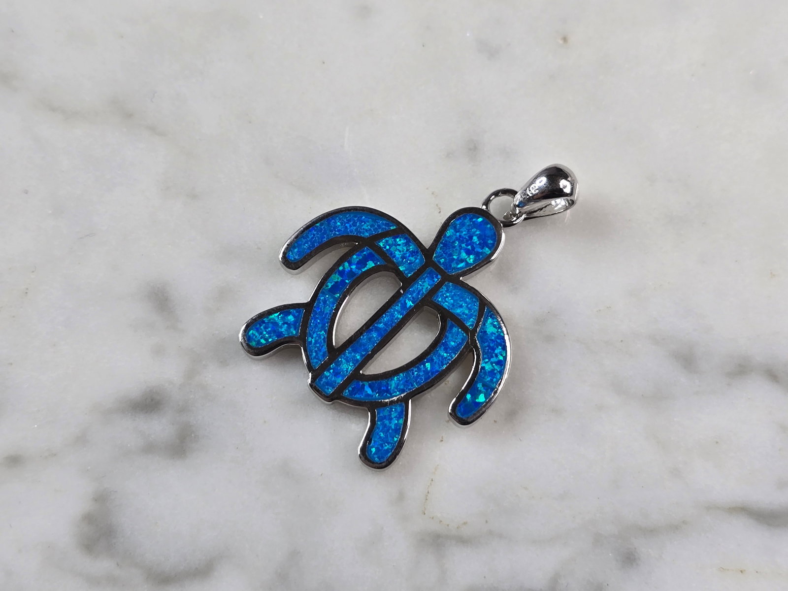 Womens Sterling Silver Blue Opal Sea Turtle Pendant: A WOMENS STERLING SILVER BLUE OPAL SEA TURTLE PENDANT. THE PENDANT WEIGHS 5.2g AND MEASURES 1 1/4" LONG BY 1" WIDE. NOT SURE IF STONES ARE REAL OR MAN MADE.MAKES A GREAT GIFT FOR THAT SOMEONE SPECIAL.