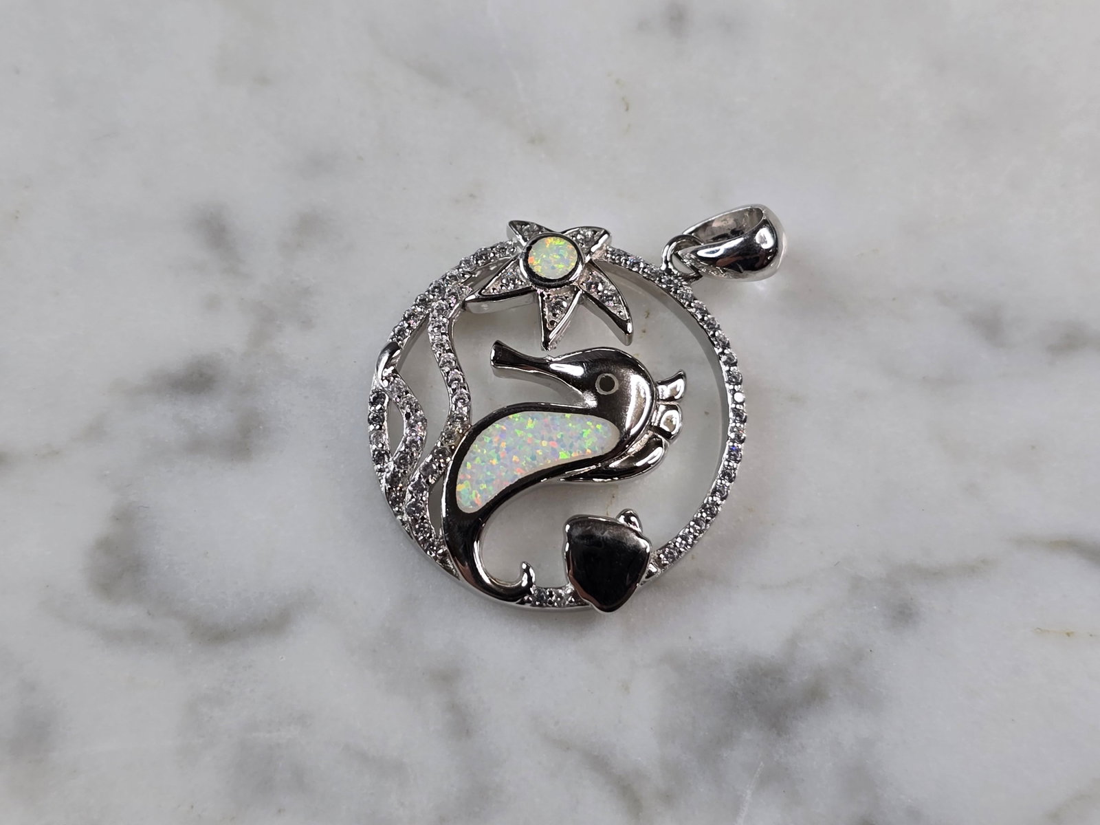Womens Sterling Silver Opal Seahorse Pendant Necklace: A WOMENS STERLING SILVER OPAL SEAHORSE PENDANT. THE PENDANT WITH NECKLACE WEIGHS 4.4g. THE PENDANT MEASURES 1 1/8" LONG BY 7/8" WIDE. NOT SURE IF STONES ARE NATURAL OR MAN MADE. MAKES A GREAT GIFT FOR