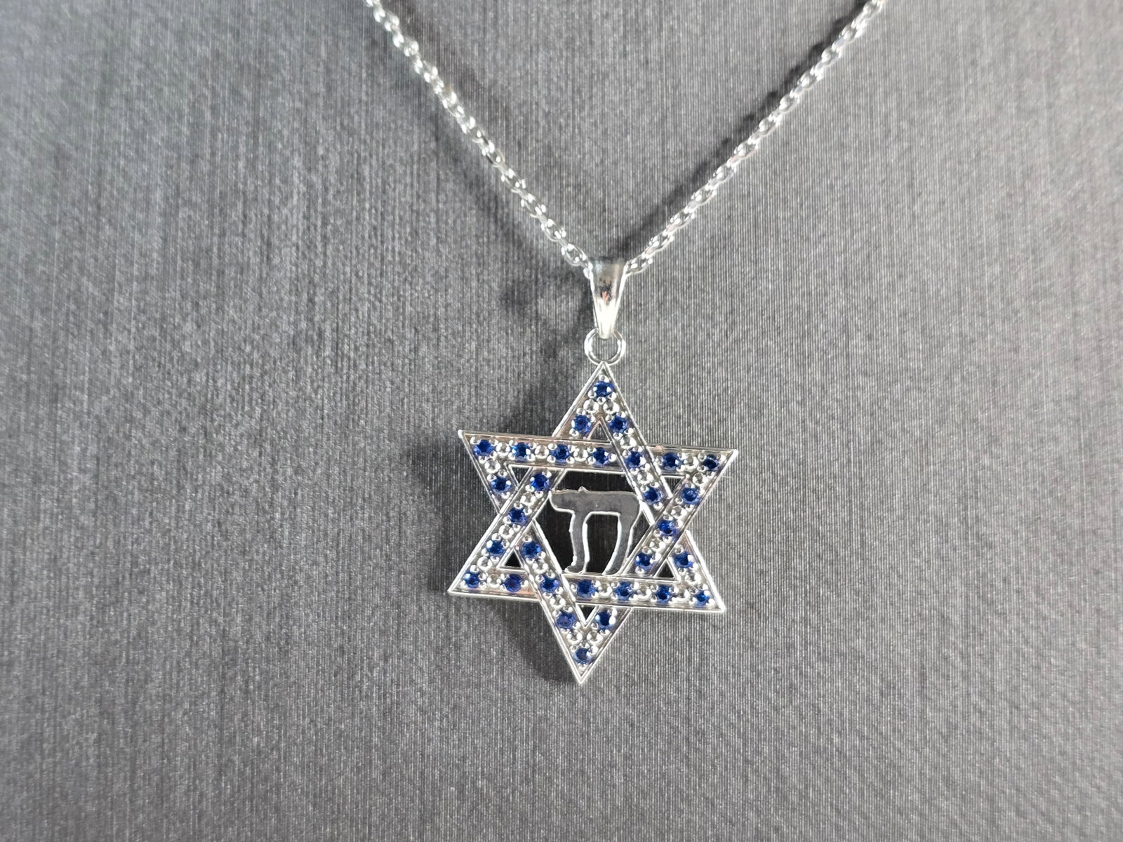 Sterling Silver Jewish Judaica Star of David Chai Pendant Necklace: A STERLING SILVER STAR OF DAVID CHAI PENDANT WITH NECKLACE. THE PENDANT WITH NECKLACE WEIGHS 3.7g. THE NECKLACE MEASURES 18" LONG, AND IS ADJUSTABLE TO 16" LONG. THE PENDANT MEASURES 1 1/8" LONG BY 3/