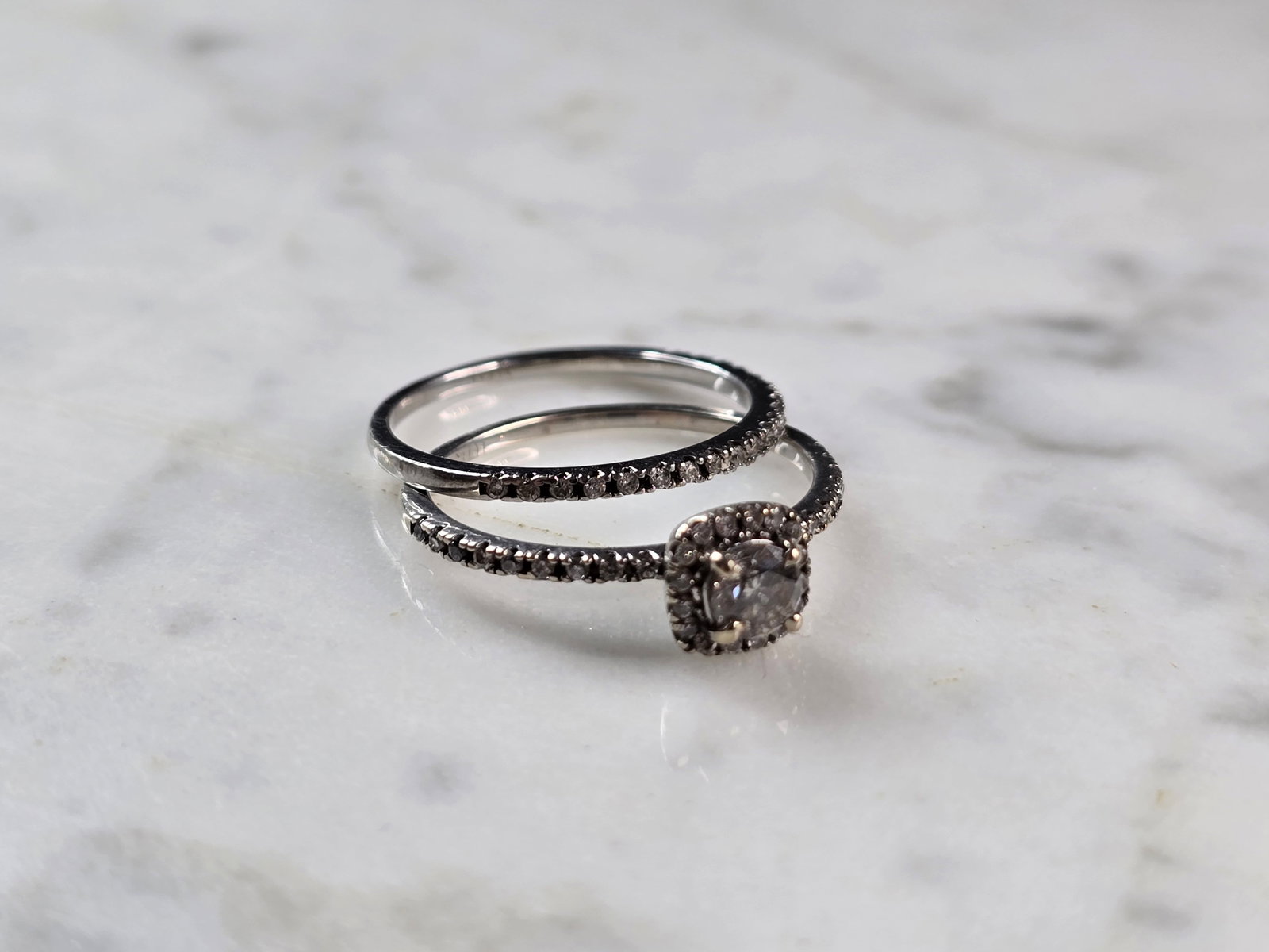 Womens Vintage Estate 10K White Gold Diamond Ring Set: A WOMENS VINTAGE ESTATE 10K WHITE GOLD DIAMOND RING SET. THE SIZE OF THE RINGS ARE 7.25 AND WEIGH 2.8g TOGETHER. THE CENTER DIAMOND IS ABOUT 0.15cts, SURROUNDED BY 16 SMALL DIAMONDS WITH 18 TINY ACCEN