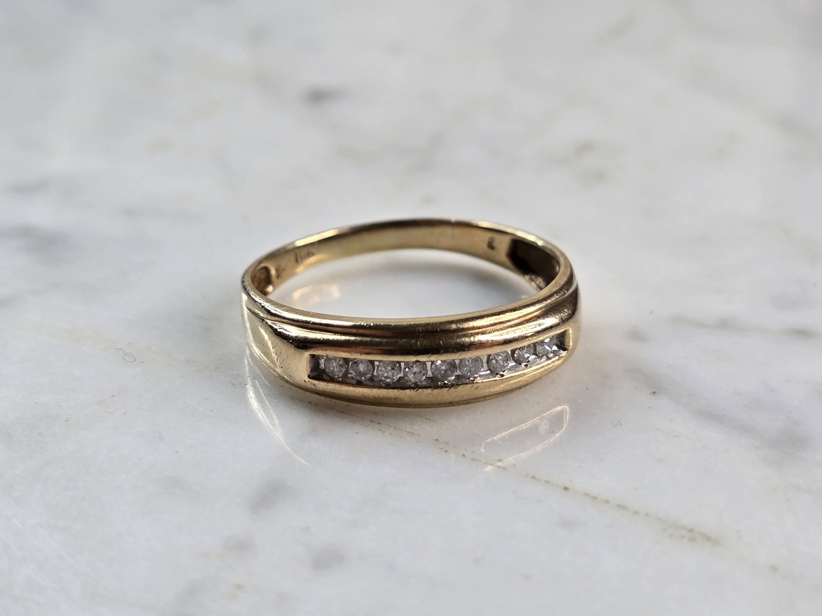 Mens Vintage Estate 10k Yellow Gold Diamond Ring: A MENS VINTAGE 10K YELLOW GOLD DIAMOND RING. THE SIZE OF THE RING IS A 12.5, AND WEIGHS 3.0g. THE WIDTH OF THE BAND IS 1/4". RING HAS 9 TINY DIAMONDS. RING IS STAMPED 10K. ANY QUESTIONS PLEASE DO NOT 