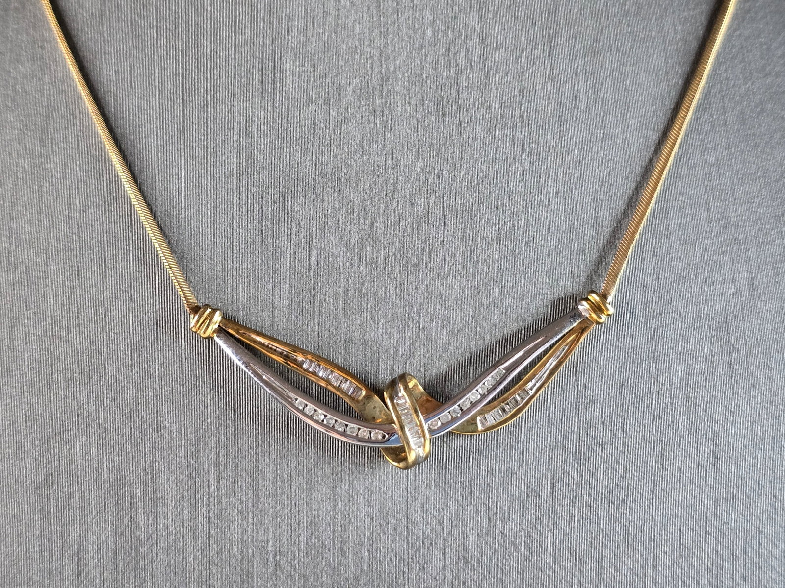 Womens Vintage Estate 10k Gold Diamond Modernist Pendant Necklace: A WOMENS VINTAGE ESTATE 10K YELLOW & WHITE GOLD DIAMOND PENDANT NECKLACE. NECKLACE WEIGHS 6.7g AND MEASURES 16 3/4" LONG, BY 1/2" WIDE. THERE ARE ABOUT .37cts OF DIAMONDS. WOULD MAKE A LOVELY GIFT FOR