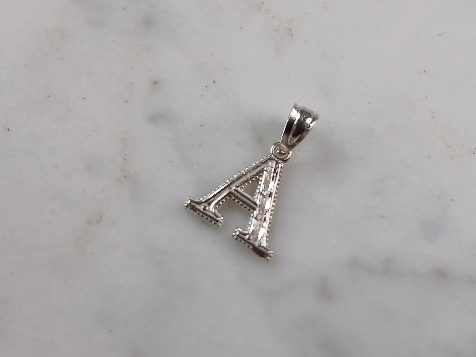Womens Sterling Silver Initial Letter " A " Pendant: A WOMENS STERLING SILVER INITIAL LETTER "A" PENDANT. PENDANT WEIGHS 0.3g AND MEASURES 5/8" LONG BY 3/8" WIDE. MAKES A GREAT GIFT FOR THAT SOMEONE SPECIAL. ANY QUESTIONS, PLEASE ASK. BE SURE TO CHECK O